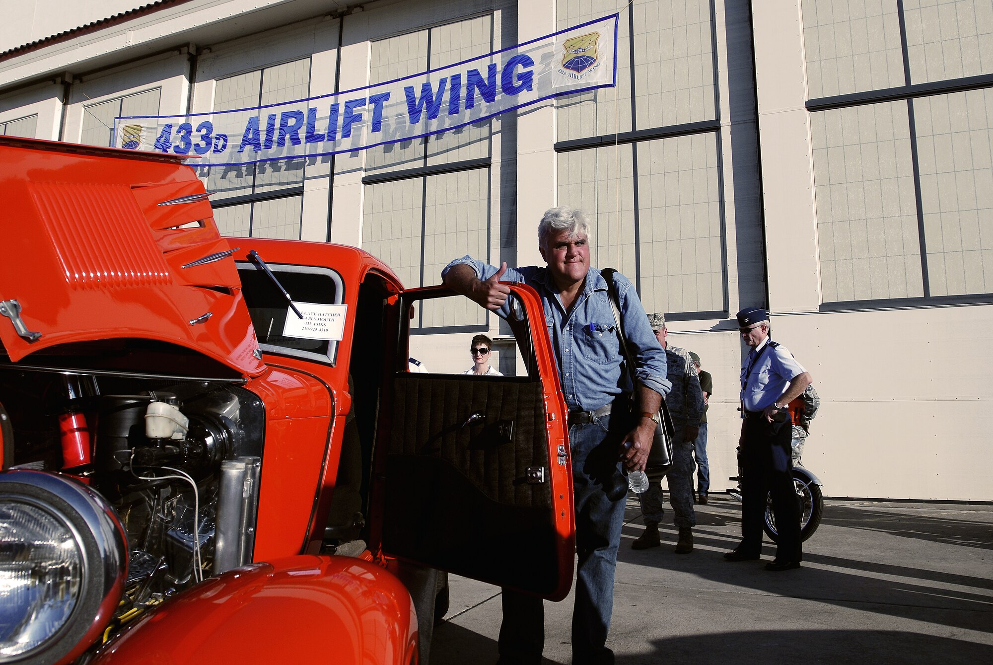Comedian and TV host, Jay Leno, gives his seal of approval for the line of classic cars and motorcycles on display for guests attending his comedic performance, Aug. 6, 2011, at Lackland Air Force Base, Texas. More than 2,000 people attended the event officially hosted by the 433rd Airlift Wing and sponsored by the Air Force Reserve Command's recruiting program, “Get 1 Now.” (U.S. Air Force photo/Senior Airman Brian McGloin)
