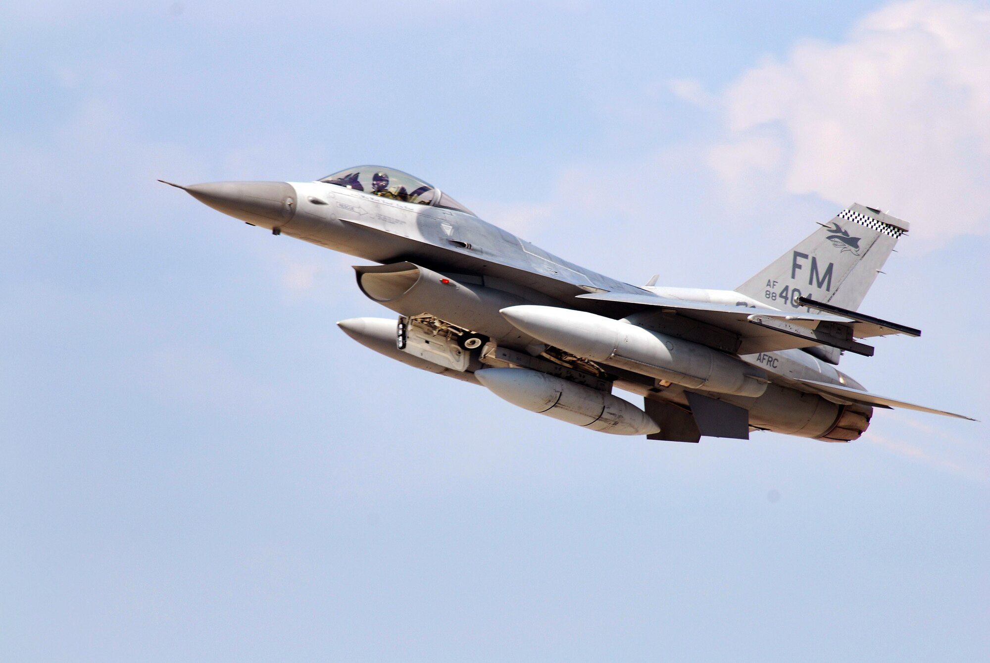 An F-16C block 30, General Electric powered fighter aircraft from the 482nd Fighter Wing at Homestead Air Reserve Base, Fla., streaks by with the maximum load of fuel and the afterburner lit at Dobbins Air Reserve Base, Ga., Aug 5. Pilots from the 93rd Fighter Squadron returned home to Florida after bringing their aircraft to Dobbins ARB as a precautionary measure to avoid possible damage from tropical storm Emily.  (U.S. Air Force photo/ Brad Fallin)