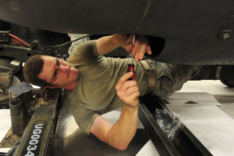 U.S. Air Force Airman 1st Class Matthew Salter, 23rd Component Maintenance Squadron aerospace propulsion apprentice, unscrews the chin scoop of an HC-130 Combat King engine at Moody Air Force Base, Ga., Aug. 8, 2011. The turbine changes are usually done when damage is found during routine inspections. (U.S. Air Force photo by Senior Airman Stephanie Mancha/Released)