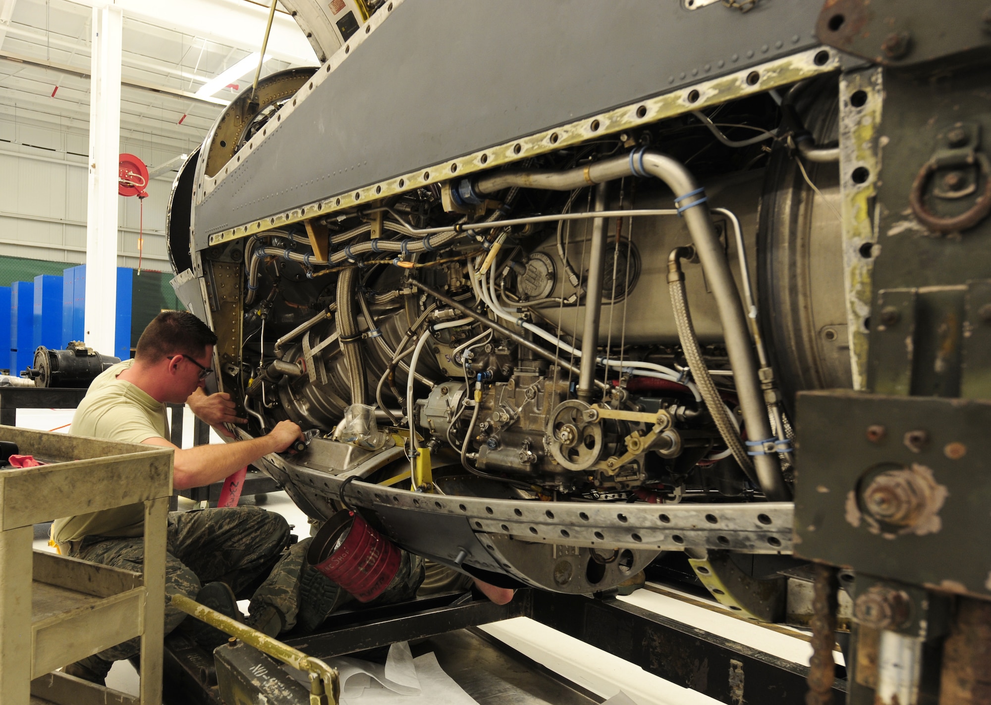 U.S. Air Force Airman 1st Class Gregory Thornton, 23rd Component Maintenance Squadron aerospace propulsion apprentice, uses a screwdriver to tighten bolts in the T-56 engine at Moody Air Force Base, Ga., Aug. 8, 2011. The T-56 engine is used in the HC-130 Combat King, an aircraft used for everything from combat delivery, humanitarian and disaster relief missions, air -to-air refueling and special operations. (U.S. Air Force photo by Senior Airman Stephanie Mancha/Released)
