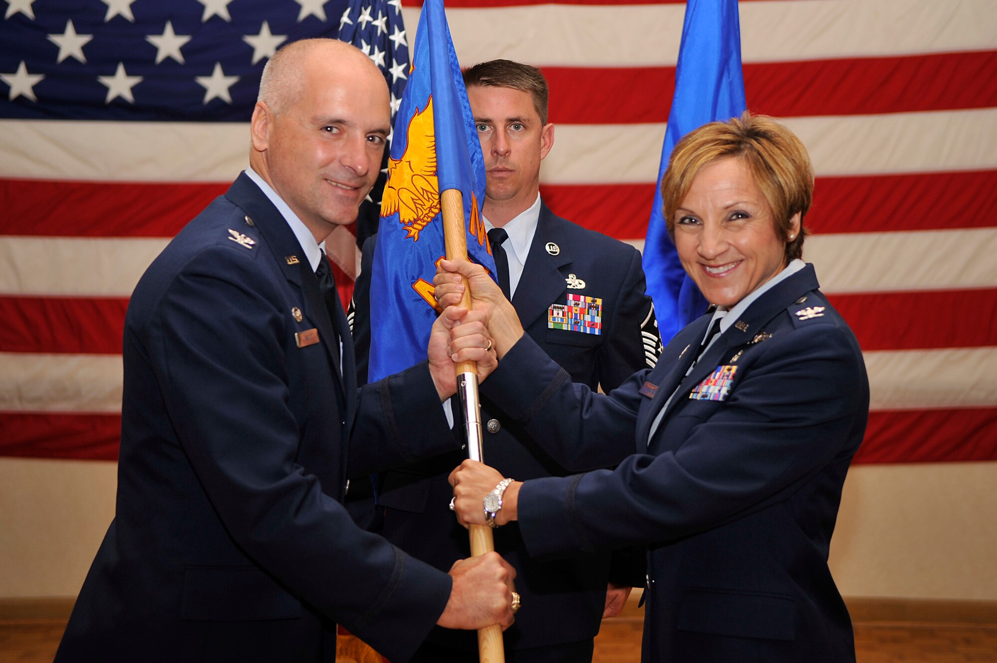 VANDENBERG AIR FORCE BASE, Calif. -- Col. Richard Boltz, 30th Space Wing commander, hands the guidon to Col. Barbara Jones, the 30th Medical Group commander, during the 30th MDG change of command ceremony at the Pacific Coast Club here Monday, Aug. 8, 2011.  (U.S. Air Force photo/Staff Sgt. Andrew Satran) 

 