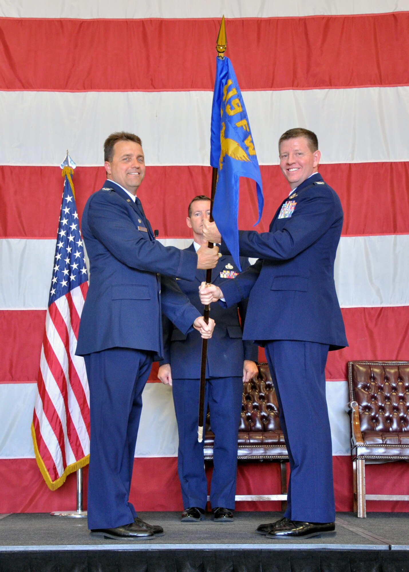 Col. Keith Knudson, 419th Fighter Wing Commander, passes the Operations Group flag to Col. Bryan Cook during his Assumption of Command Ceremony Sunday. (U.S. Air Force photo/Airman 1st Class Crystal Charriere)
