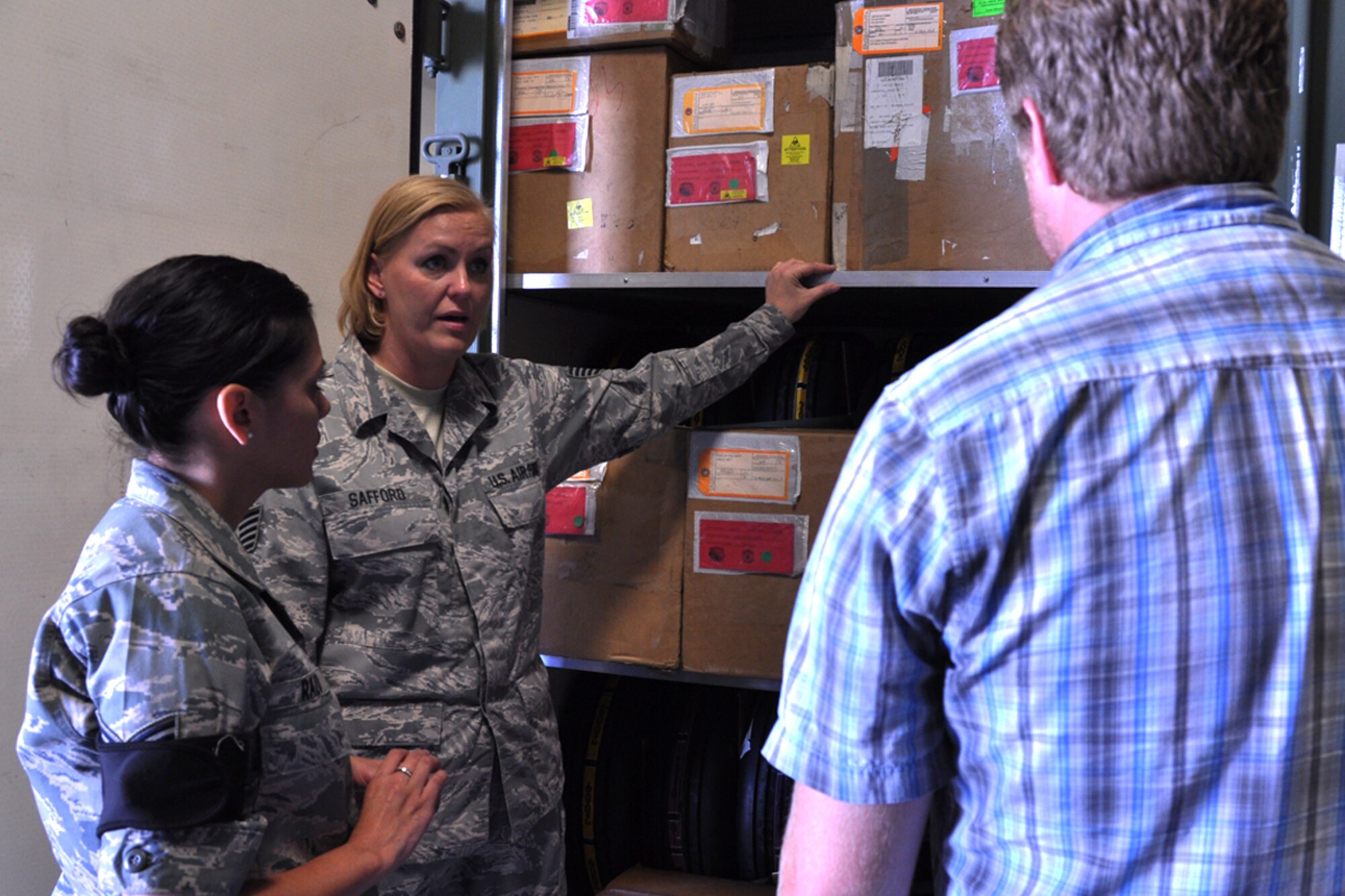 Tech. Sgt. Eileen Safford, the 419th Logistics Readiness Squadron’s maintenance supply liaison, and Senior Airman Edna Razo, also a supply troop, explain the supply system to Razo’s civilian employer, Nathan Anderson of Nucor Building Systems in Brigham City. Razo hosted Anderson on a tour of her work area as part of Employer Appreciation Day activities Sunday. (U.S. Air Force photo/Staff Sgt. Heather Skinkle)