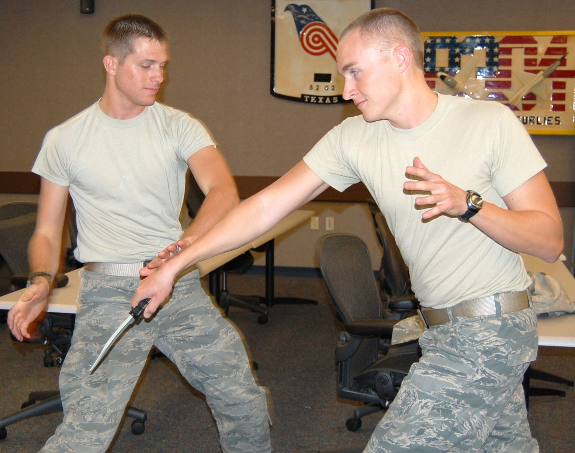 LAUGHLIN AIR FORCE BASE, Texas - - Second Lt. Benjamin Skee, 47th Operations Support Squadron, (left) demonstrates how to react in a combat situation. Skee is teaching Krav Maga in Laughlin’s Losano Fitness Center’s aerobics room Tuesdays and Thursdays at 7 p.m. (U.S. Air Force photo by Gaby Jimenez)
