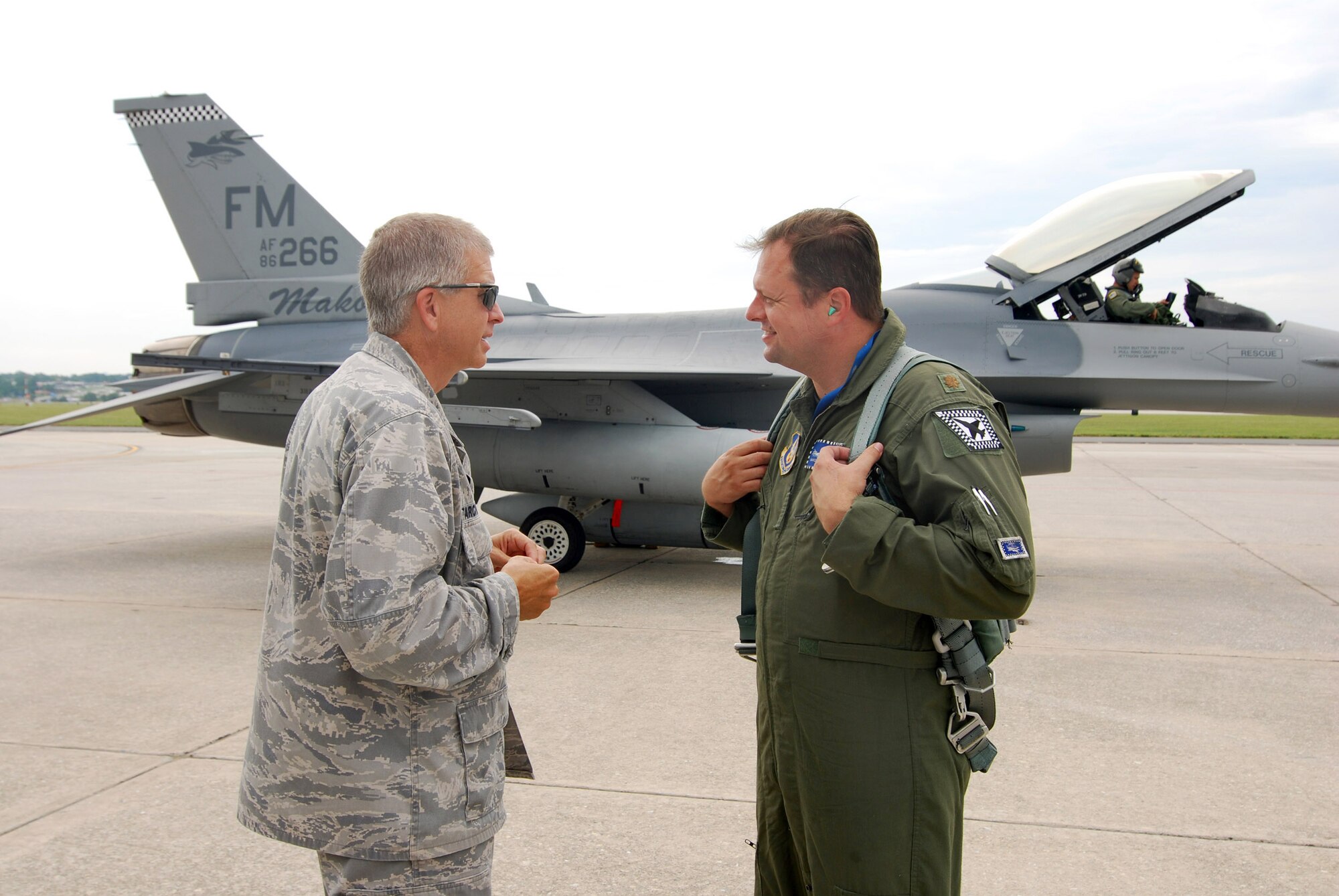 Col. Tim Tarchick, 94th Airlift Wing commander, greets 482nd Fighter Wing F-16C pilot and Atlanta local, Maj. Chad Goldizen, upon his arrival at Dobbins Air Reserve Base, Aug 4.  Maj. Goldizen flew in with 13 other pilots from the 93 Fighter Squadron based at Homestead Air Reserve Base, Fla.  The F-16C block 30 fighter jets are being moved from Homestead ARB as a precautionary measure to avoid possible damage from tropical storm Emily, currently brewing in the Atlantic Ocean.  (U.S. Air Force photo/ Brad Fallin)