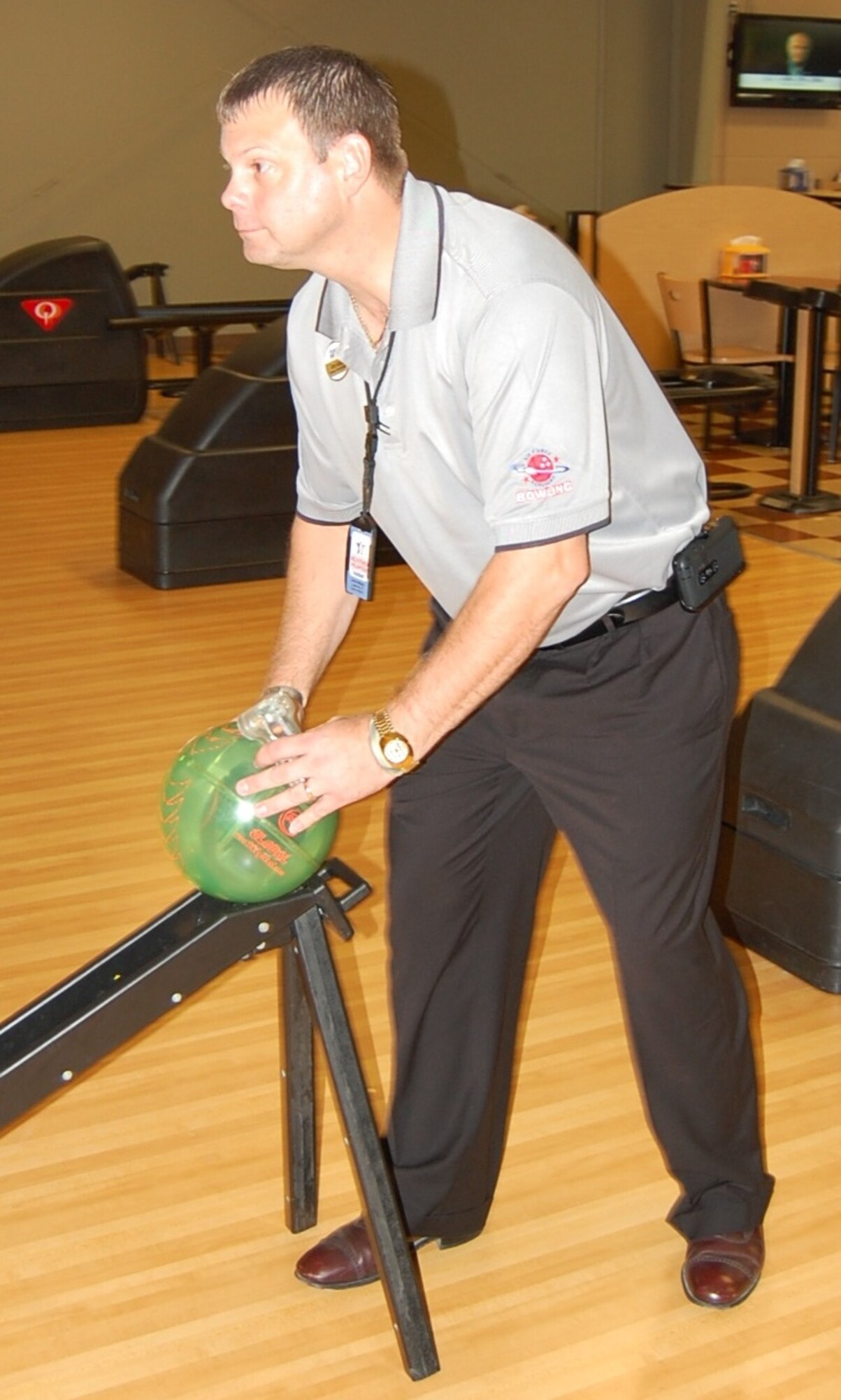 LAUGHLIN AIR FORCE BASE, Texas-- Jimmy Hedtkamp, Laughlin’s Cactus Lanes Bowling Center manager, demonstrates how to use a remote-controlled bowling ball that controls a bowling video game at Cactus Lanes Aug. 3. Bowlers have the opportunity to play the game through Aug. 22. (U.S. Air Force photo by Laura Salazar)