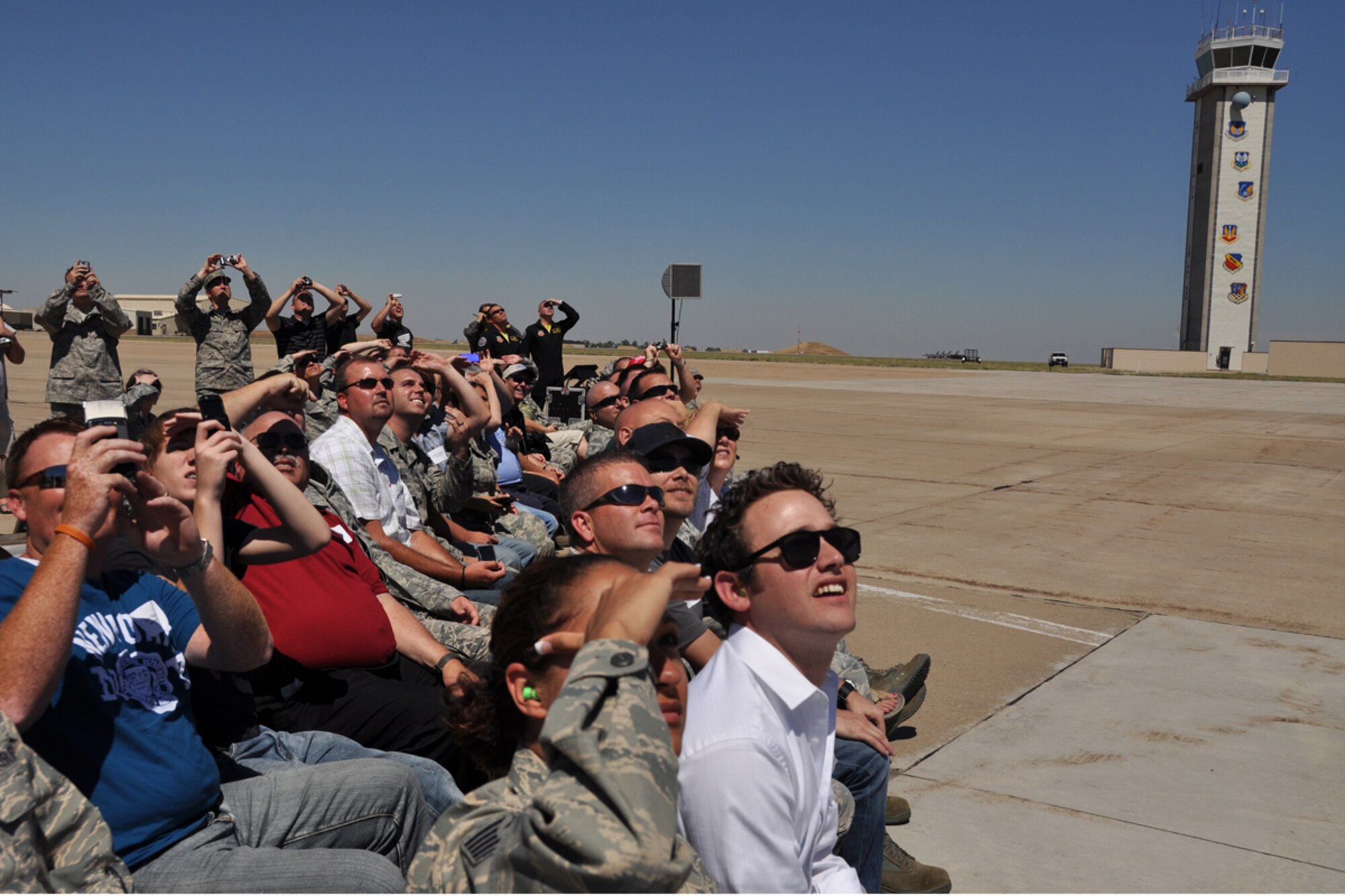Employer Appreciation Day attendees look skyward at an F-16 Viper West aerial demonstration during Employer Appreciation Day here Sunday. (U.S. Air Force photo/Staff Sgt. Heather Skinkle)