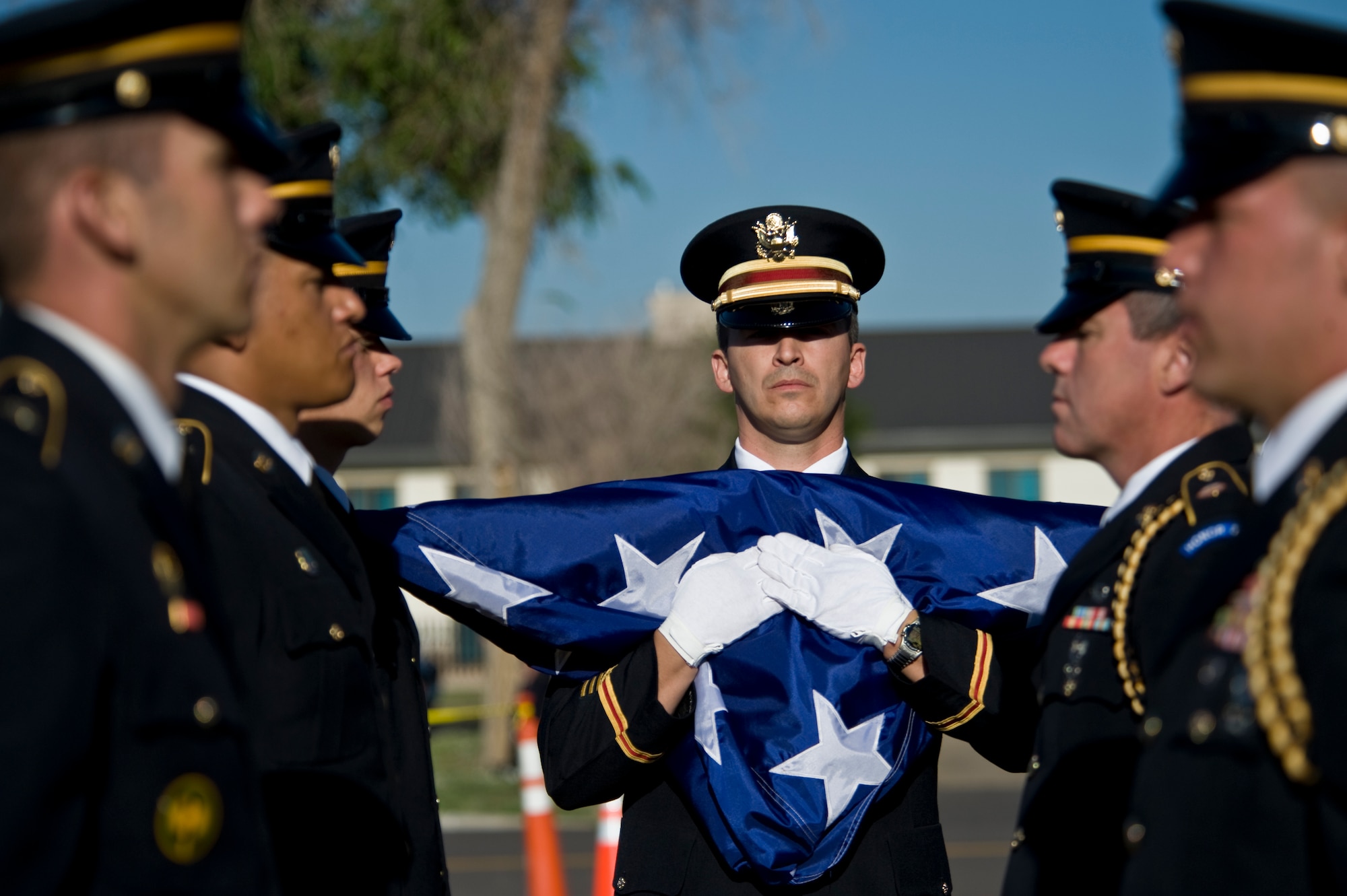 BUCKLEY AIR FORCE BASE, Colo. -- Colorado Army National Guardsmen remain in line after folding a flag that draped steel remnants of the World Trade Center stored here overnight Aug. 8, 2011. The steel pieces will make their way through downtown Denver before finding a final resting place in different memorials in the local metro area. (U.S. Air Force photo by Staff Sgt. Kathrine McDowell)