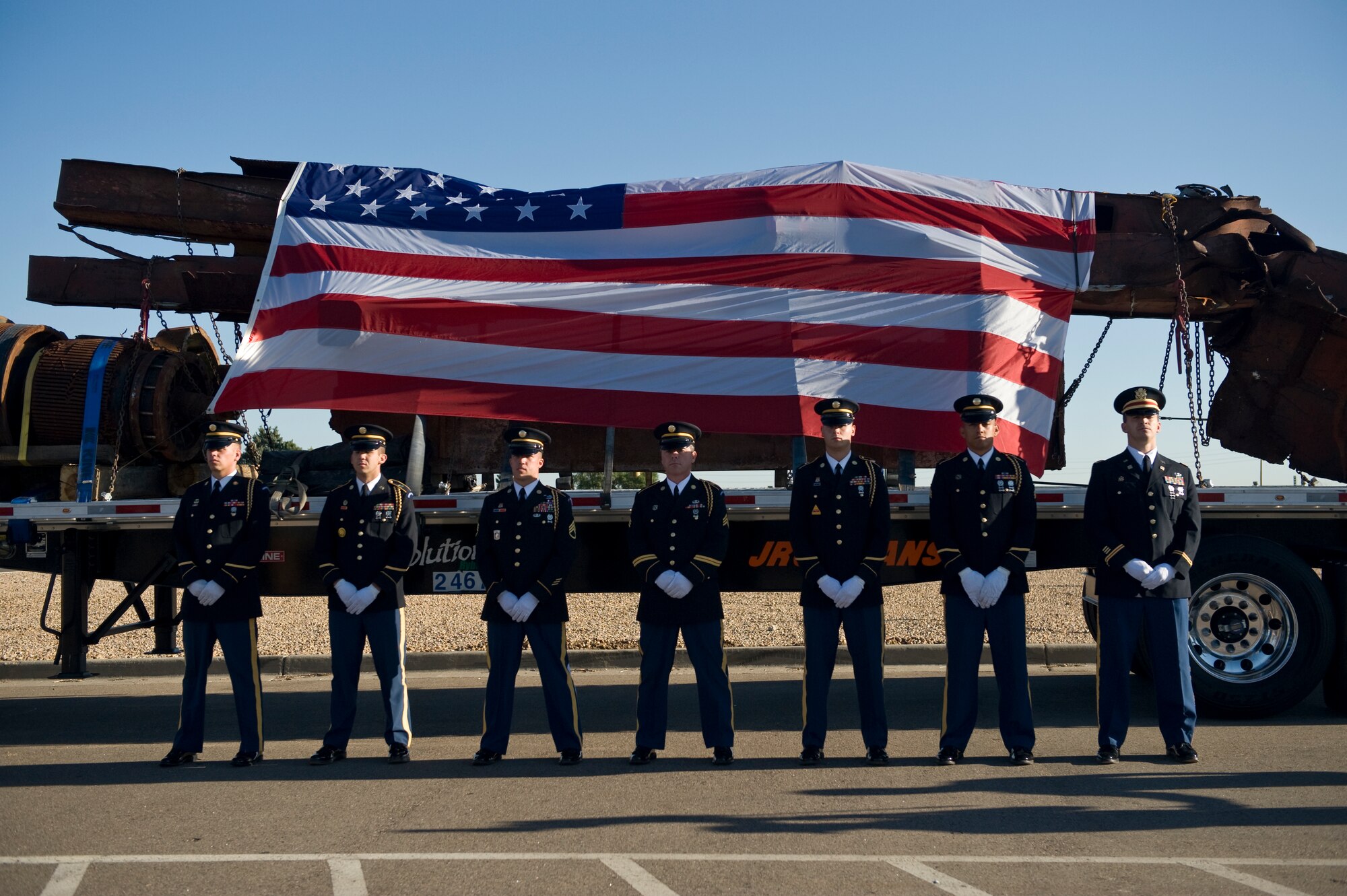 BUCKLEY AIR FORCE BASE, Colo. -- Colorado Army National Guardsmen line up in front of steel remnants recovered from the World Trade Center site Aug. 7, 2011. The shipment stayed overnight at Buckley AFB en route to downtown Denver, Colo. The pieces will have their final resting place at different memorials in the local metro area. (U.S. Air Force photo by Staff Sgt. Kathrine McDowell)