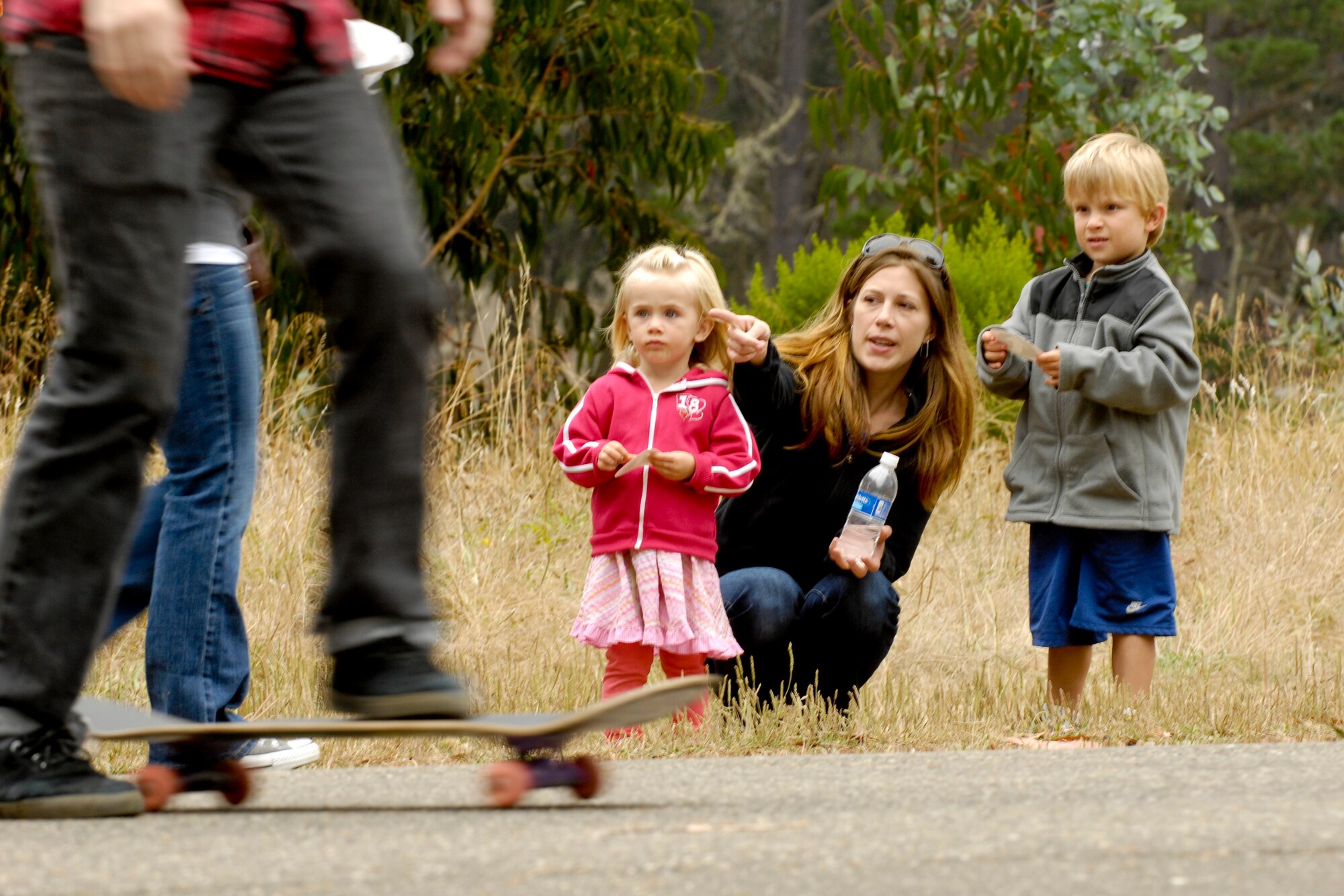 Vandenberg Air Force Base, Calif. -- Jamie, Malory and Donovan Malone, Team V dependents, watch a skate board event during the 23rd Annual Texas Blowout at Cocheo Park here Friday, Aug. 5, 2011. (U.S. Air Force/Staff Sgt. Levi Riendeau)