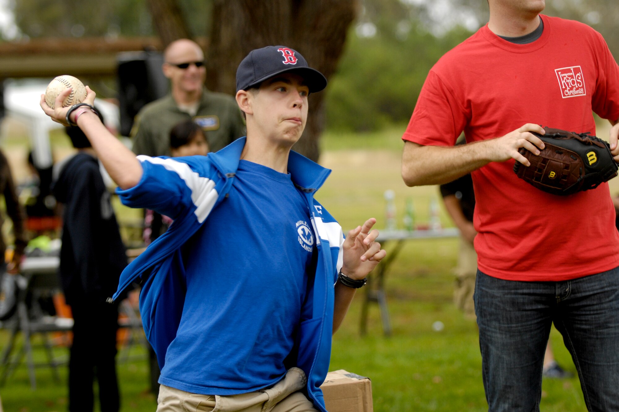 Vandenberg Air Force Base, Calif. -- Kyle Lutton, a Team V dependent, throws a softball at the dunk tank during the 23rd Annual Texas Blowout at Cocheo Park here Friday, Aug. 5, 2011.  The 30th Space Wing commander, Col. Richard Boltz, sat in the dunk tank for Team V members.  (U.S. Air Force/Staff Sgt. Levi Riendeau)