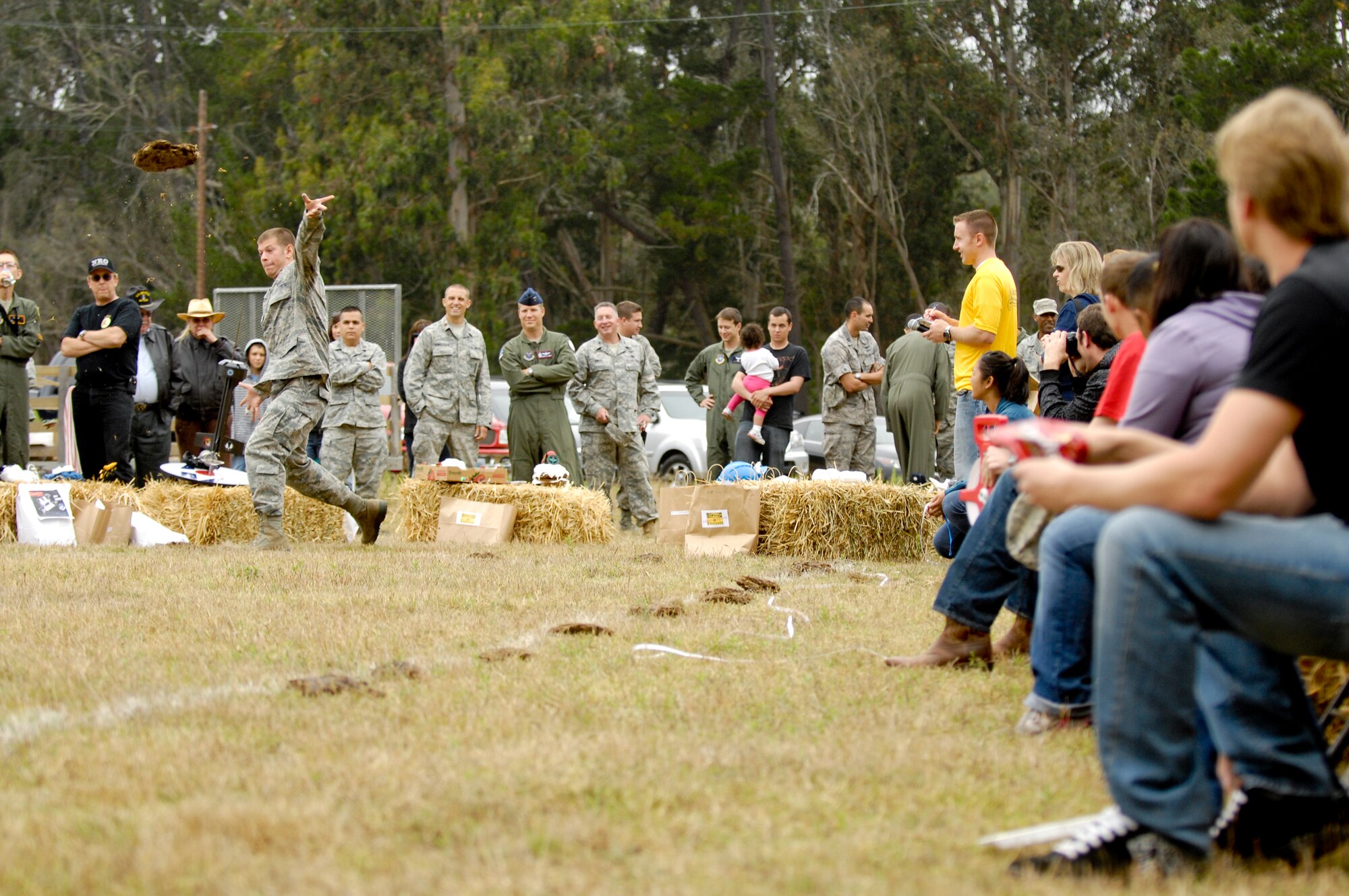 Vandenberg Air Force Base, Calif. -- A Team V member throws a cow pie during the 23rd Annual Texas Blowout here Friday, Aug. 5, 2011. The Texas Blowout, which featured numerous family-fun activities, is a barbecue coordinated by 392nd Training Squadron personnel to raise funds for Operation Kids Christmas, an annual event in which the men and women of Vandenberg sponsor approximately 200 local underprivileged children during the holidays. (U.S. Air Force/Staff Sgt. Levi Riendeau)