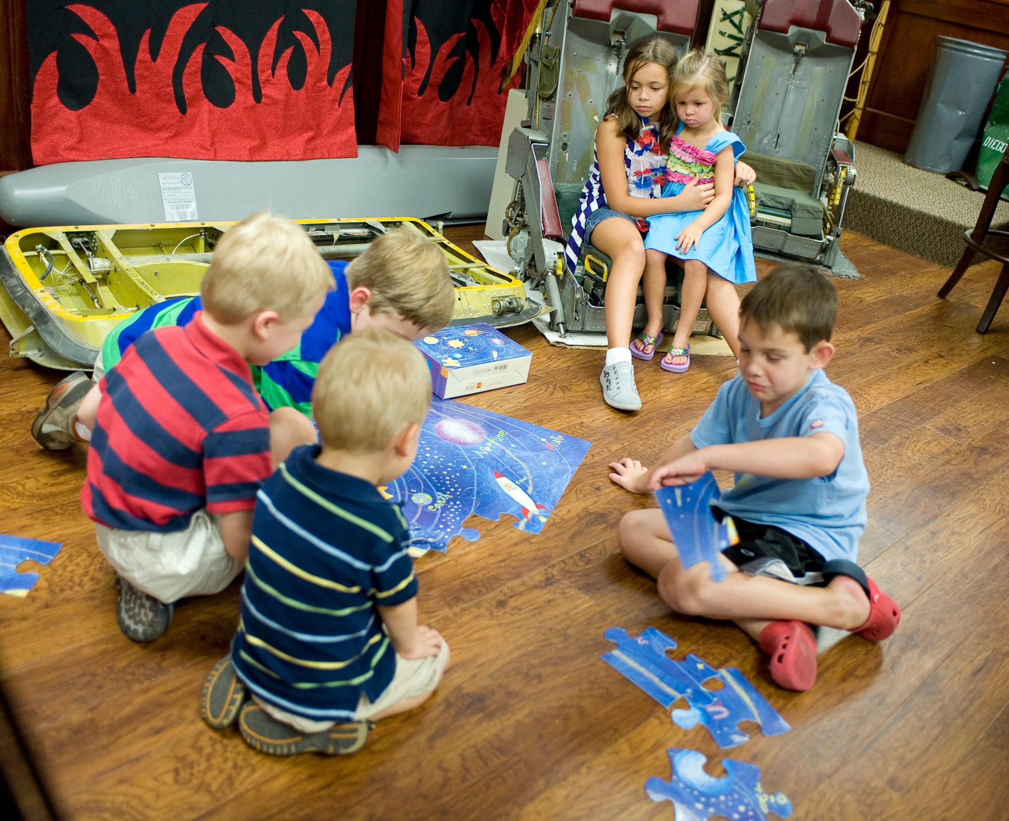 Children wait for their family members to return home from a deployment in the Heritage Room at the 96th Bomb Squadron on Barksdale Air Force Base, La., Aug. 5. The Airmen are returning from a deployment to Andersen Air Force Base, Guam, in support of the continuous bomber presence in the pacific region. (U.S. Air Force photo/Senior Airman Chad Warren)(RELEASED)