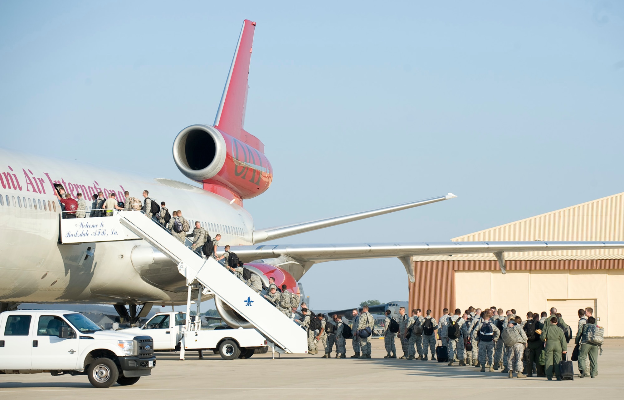 Airmen board a plane to Andersen Air Force Base, Guam, on the flight line of Barksdale Air Force Base, La., Aug. 4. The Airmen are beginning a four month deployment in support of the continuous bomber presence in the pacific region. (U.S. Air Force photo/Senior Airman Chad Warren)(RELEASED)