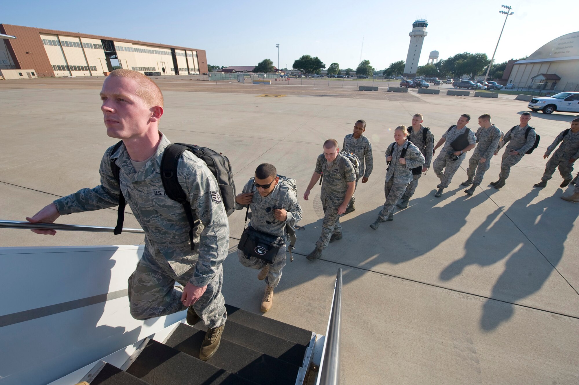 Airmen board a plane to Andersen Air Force Base, Guam, on the flight line of Barksdale Air Force Base, La., Aug. 4. The Airmen are beginning a four month deployment in support of the continuous bomber presence in the pacific region. (U.S. Air Force photo/Senior Airman Chad Warren)(RELEASED)