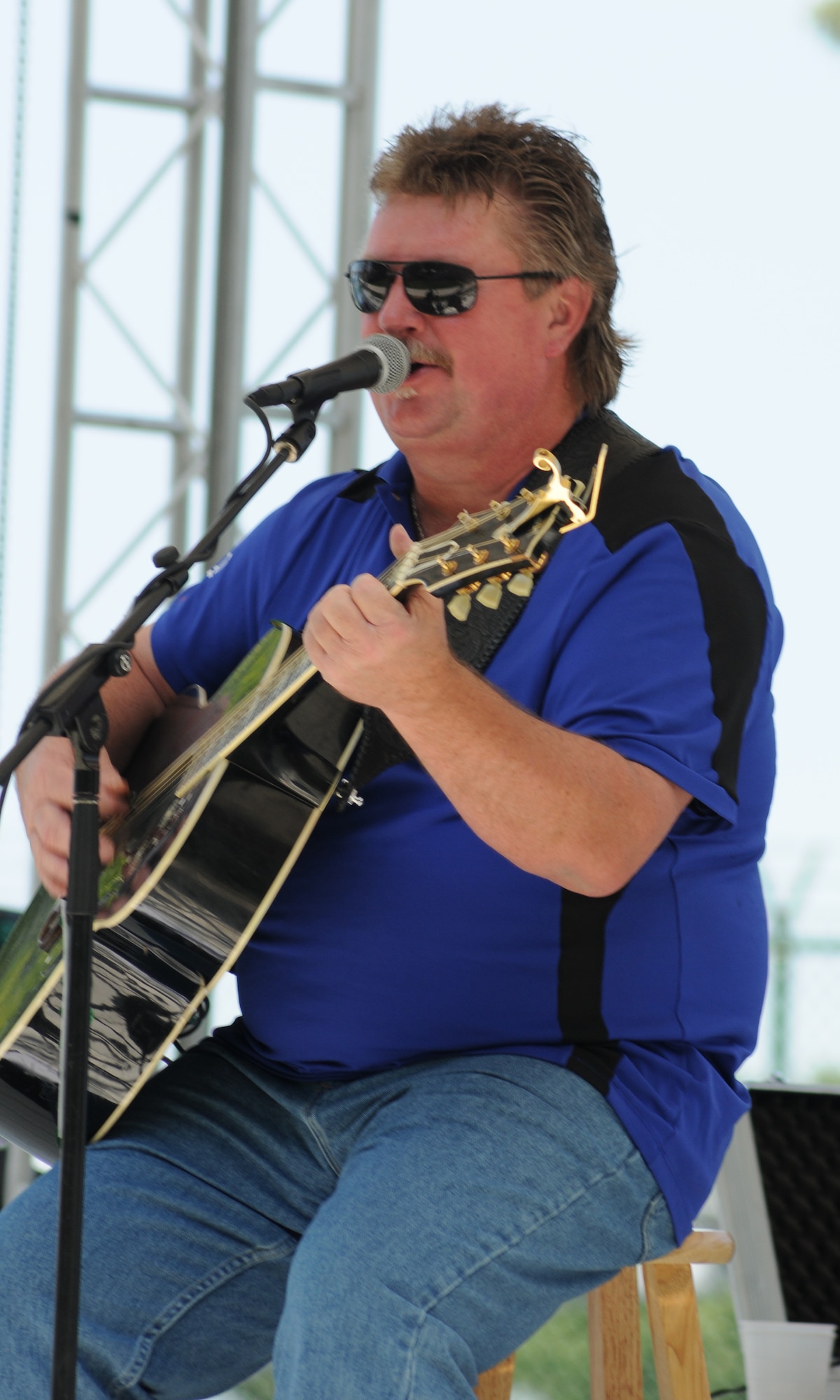 Joe Diffie performs before 2,000 people at the 512th Airlift Wing biennial picnic Aug. 6 at Eagle?s Nest. He has had 35 songs on the Billboard Hot Country chart including five number one singles such as ?Third Rock from the Sun? and ?Pickup Man?. The Air Force Reserve sponsored the musician as part of the Get One Now program, a recruiting tool reservists can use to refer people interested in joining the AF Reserve. (U.S. Air Force photo by Capt. Marnee A.C. Losurdo)