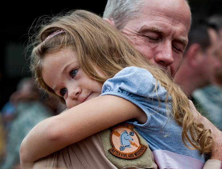 Lt. Col. Thomas Frazier of the 711th Special Operations Squadron receives a overdue hug from his daughter after returning from a deployment to Southwest Asia, Aug. 7.  More than 25 Air Force Reserve Airmen were welcomed back home at a homecoming party at Duke Field.  (U.S. Air Force photo/Tech. Sgt. Samuel King Jr.)