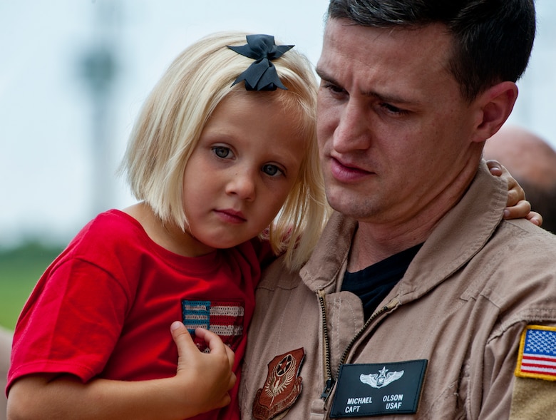 Capt. Michael Olson of the 711th Special Operations Squadron, keeps his 4-year-old daughter, Lillian, in his arms after returning from a deployment to Southwest Asia, Aug. 7.  Olson, along with 25 other Air Force Reserve Airmen were welcomed back at a homecoming party at Duke Field.  (U.S. Air Force photo/Tech. Sgt. Samuel King Jr.)
