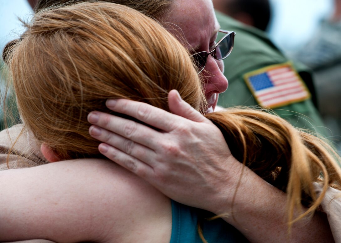 Tech. Sgt. Catherine Evers of the 711th Special Operations Squadron, holds her daughter, Amber close after returning from a deployment to Southwest Asia, Aug. 7.  Evers did not know her daughter would be at the Duke Field homecoming and was overtaken by emotion when she saw her daughter's face.  (U.S. Air Force photo/Tech. Sgt. Samuel King Jr.)