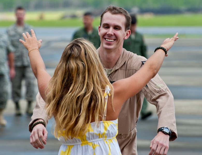 Senior Airman David Mobley of the 711th Special Operations Squadron, runs to embrace his girlfriend after returning from a deployment to Southwest Asia, Aug. 7.  Mobley, along with 25 other Air Force Reserve Airmen were welcomed back at a homecoming party at Duke Field.  (U.S. Air Force photo/Tech. Sgt. Samuel King Jr.)