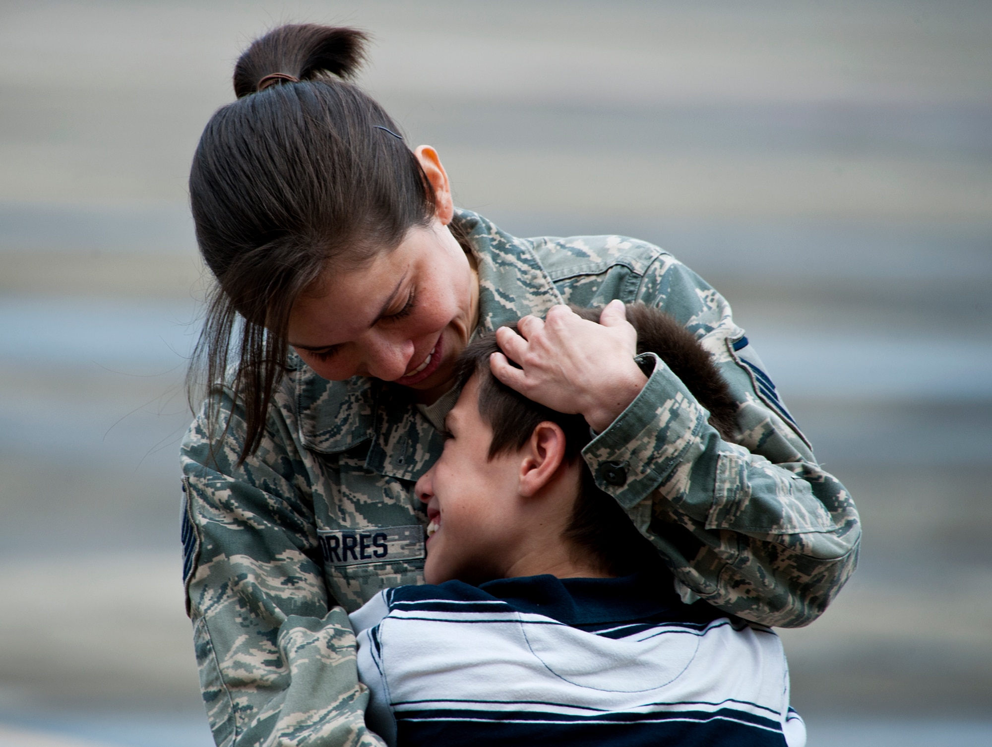 Master Sgt. Adriana Torres of the 711th Special Operations Squadron, admires her smiling son upon her return from a deployment to Southwest Asia, Aug. 7.  More than 25 Air Force Reserve Airmen were welcomed back home at a homecoming party at Duke Field.  (U.S. Air Force photo/Tech. Sgt. Samuel King Jr.)