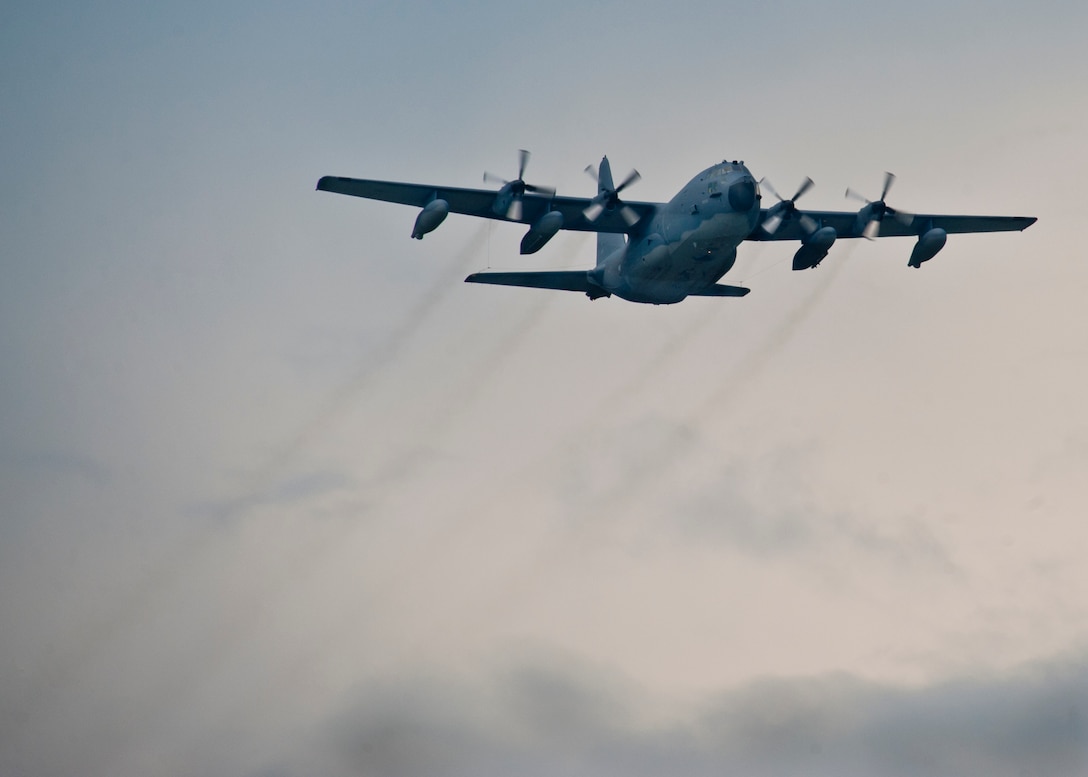 A MC-130E Combat Talon I passes over the Duke Field runway before bringing home more than 25 Airmen back to their families after a deployment to Southwest Asia, Aug. 7.  (U.S. Air Force photo/Tech. Sgt. Samuel King Jr.)