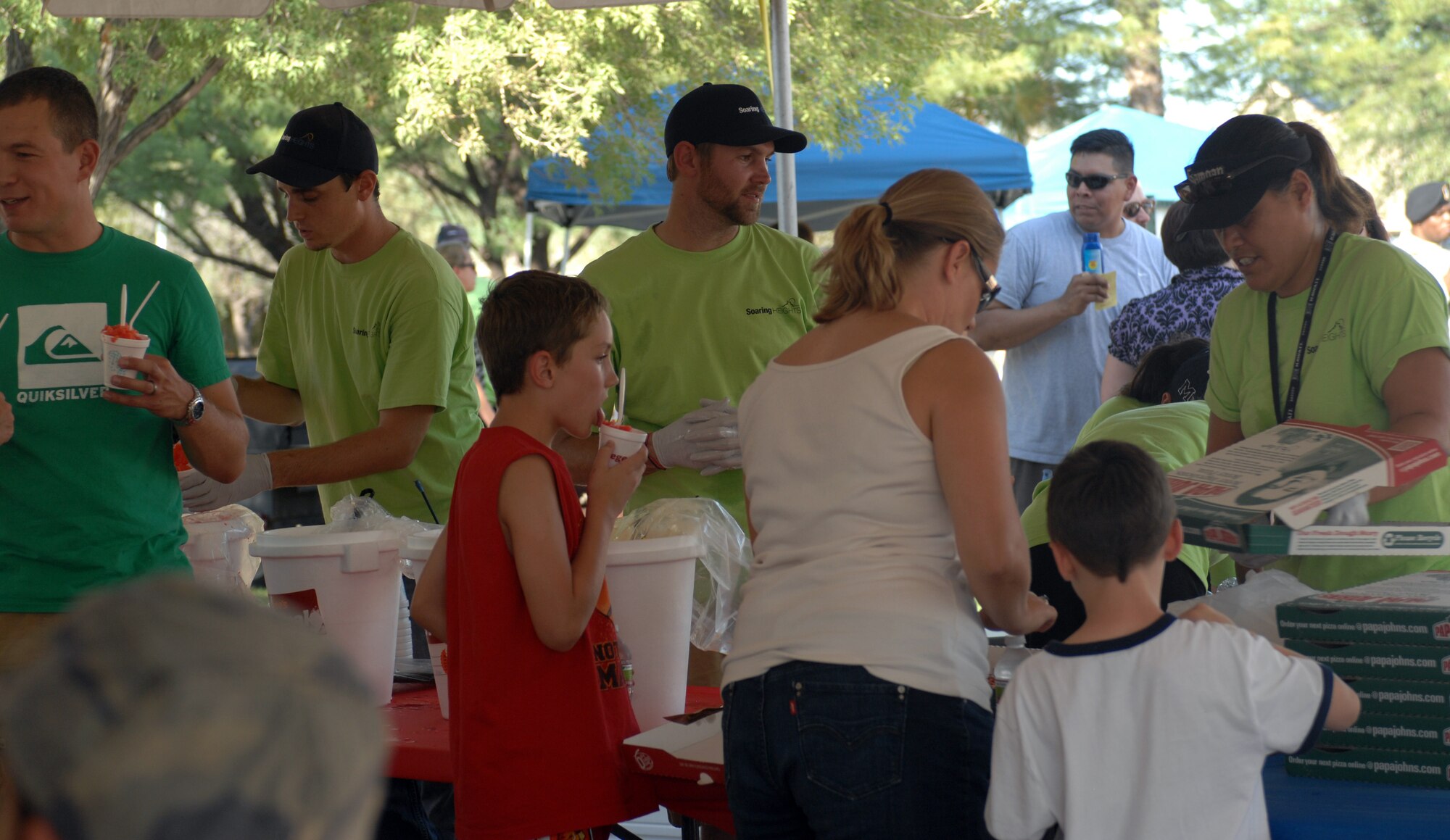 DAVIS-MONTHAN AIR FORCE BASE, Ariz. – Workers from Soaring Heights Communities serve food and beverages to residents during the National Night Out event here Aug. 2. Soaring Heights Communities hosted the event to promote neighborhood and police-community partnership. (U.S. Air Force photo/Airman 1st Class Timothy D. Moore)