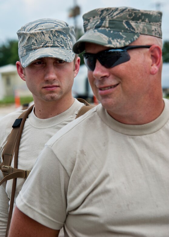 Senior Airman Nicholas Shoupe, from the 919 Security Forces Squadron, secures Staff Sgt. Patrick Warnick's hands behind his back during flightline entry control procedures training at Duke Field, Aug. 6.  (U.S. Air Force photo/Tech Sgt. Samuel King Jr.)