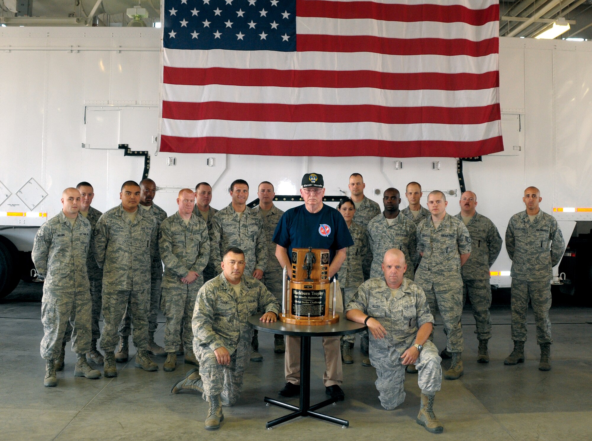 Col. Don Adams, 90th Maintenance Group commander, Col. (ret) Chuck Blackburn, and Chief Master Sgt. Monty Reeder, 90th MXG superintendent, pose for a photo with the Blackburn trophy and the maintenance team for the 2011 Global Strike Challenge. The team members are, Senior Airman Joseph Brown, Senior Airman Dustin Klepinger, Staff Sgt. Danilo Dancel, Airman 1st Class Nicholas Moore, Tech. Sgt. Jeremy Spranger, Senior Airman Devin Whitehead, Staff Sgt. Jarrod White, Senior Airman Benjamin Johnson, Staff Sgt. Sheila Perez-Rivera, Tech. Sgt. Andrew Ming, Staff Sgt. Andrew Stovall, Staff Sgt. Guy McCutcheon, Staff Sgt. Keith Liberty, Master Sgt. Randal Schroeder, and Tech. Sgt. Angel Santiago-Zapata. (U.S. Air Force photo by Blaze Lipowski)