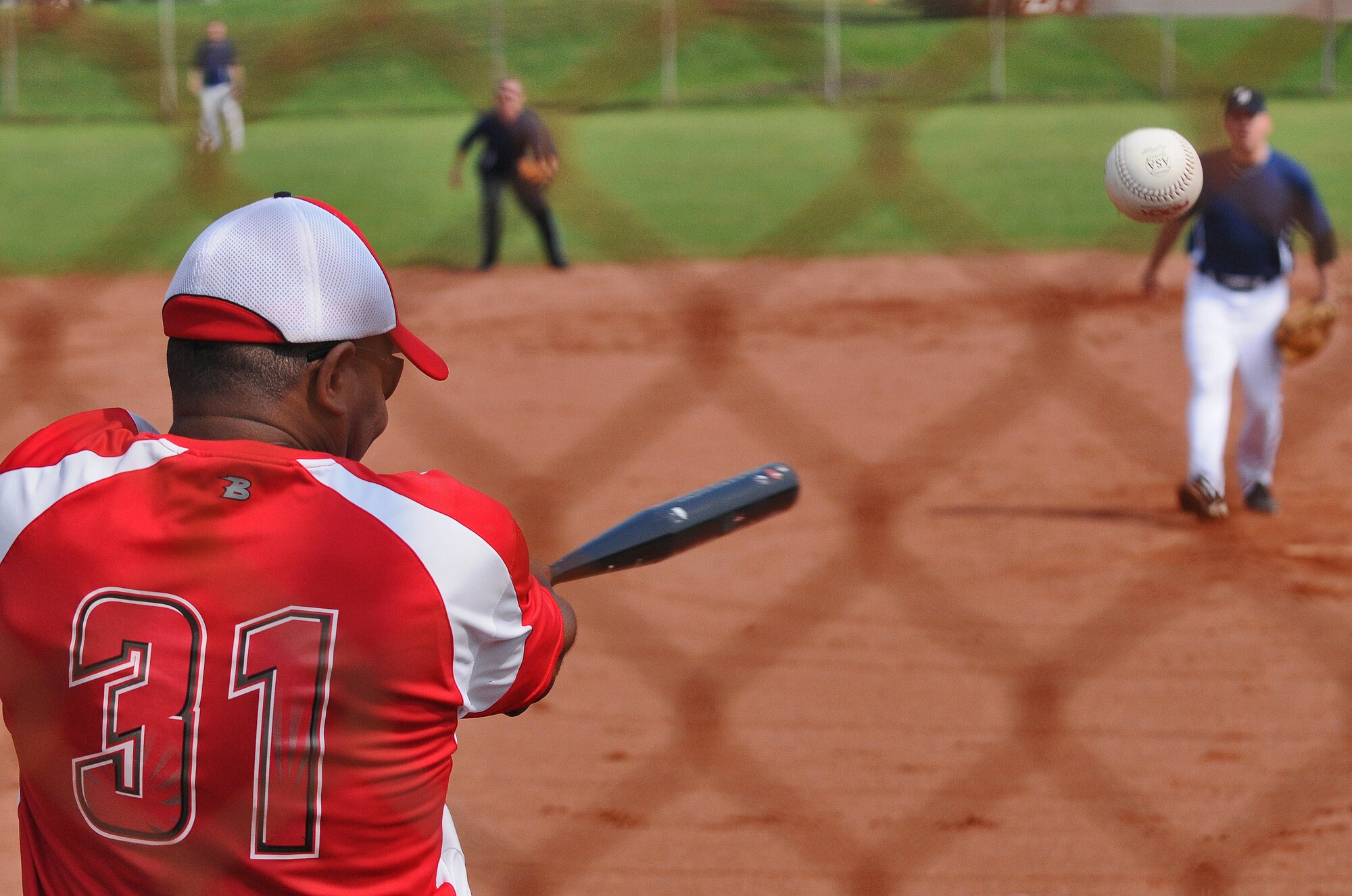 SPANGDAHLEM AIR BASE, Germany – Benny Dixon, Royal Air Force Croughton Cougars, hits a ball into the outfield during a U.S. Air Forces in Europe Small Units Softball Tournament game against the 606th Air Control Squadron Galley Warriors here Aug. 4. The 726th Air Mobility Squadron won the tournament or out the seven teams from across Europe that competed. (U.S. Air Force photo/Senior Airman Nick Wilson)