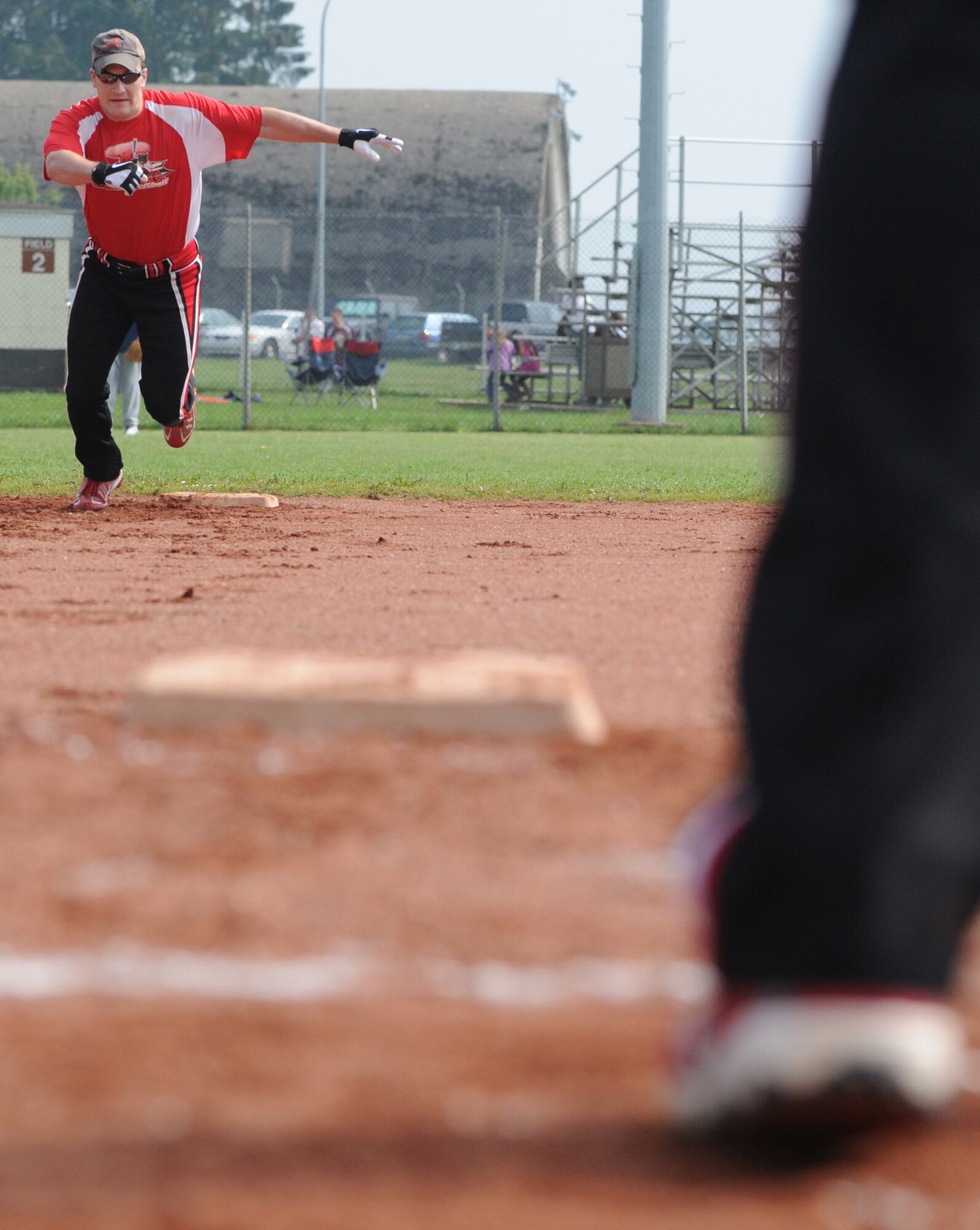SPANGDAHLEM AIR BASE, Germany -- Michael Esarey, Royal Air Force Croughton Cougars, sprints to third base during a U.S. Air Forces in Europe Small Units Softball Tournament game against the 606th Air Control Squadron Galley Warriors here Aug. 4. The 726th Air Mobility Squadron won the tournament or out the seven teams from across Europe that competed. (U.S. Air Force photo/Senior Airman Nick Wilson)