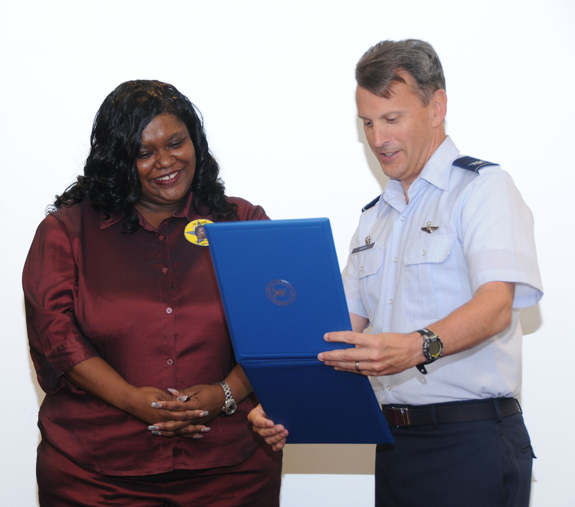 Ms. Lisa Jokines, (left) receives her 20-year federal service certificate from Col. Randy Ogden, 916th Air Refueling Wing commander. Ms. Jokines is a key member of wing staff. (USAF photo by 916th Public Affairs)