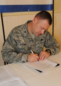 Col. Richard McComb signs his lease to live in privatized base housing at the Charleston Club at Joint Base Charleston - Air Base Aug. 5. Forest City Military Communities, which manages JB CHS- AB housing, held the lease signing event and encouraged all residents to stop by the Charleston Club and sign their leases. The transition to privatized housing takes place Oct.1. McComb is the Joint Base Charleston commander. (U.S. Air Force photo/ Airman 1st Class Ashlee Galloway) 