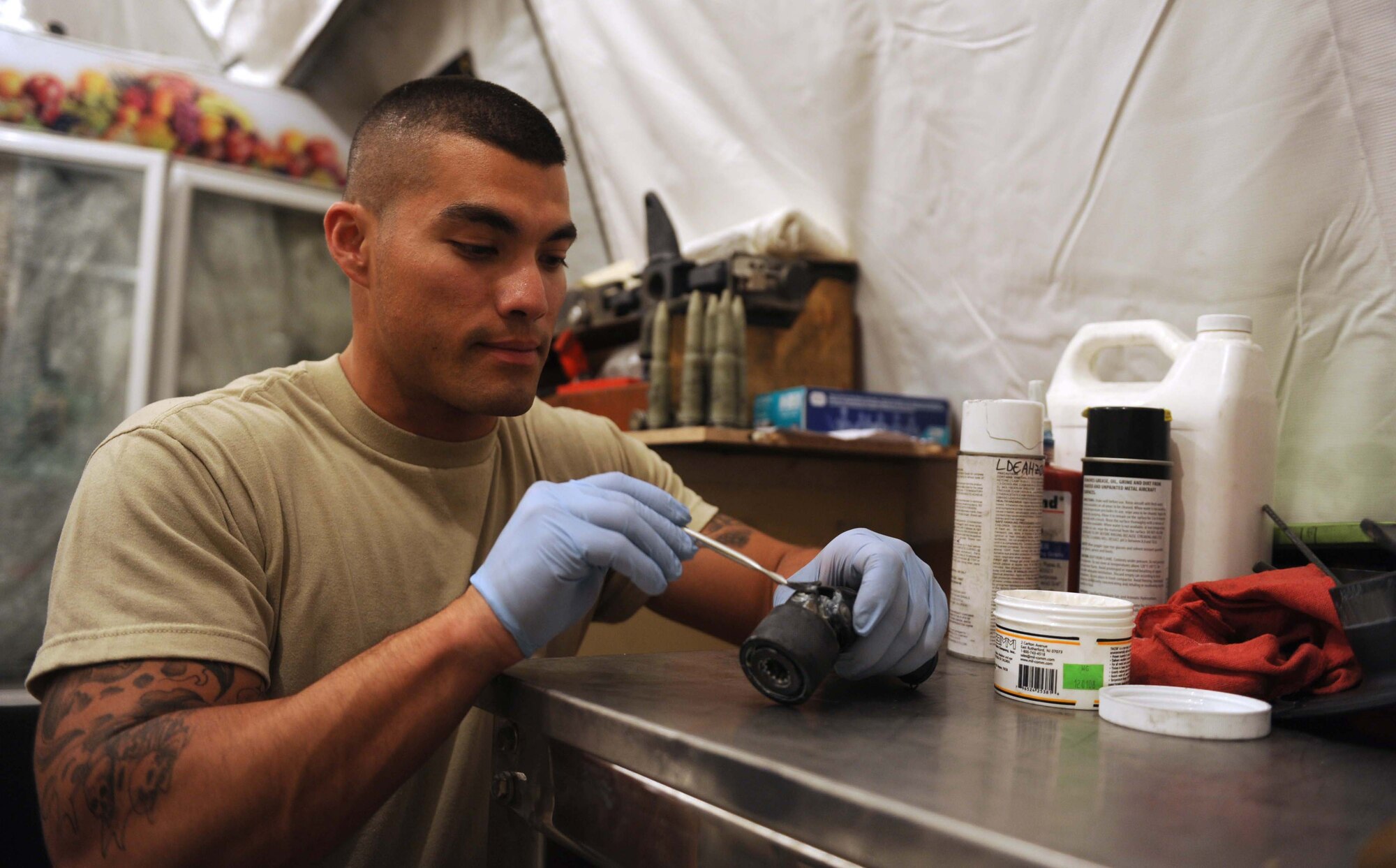 Senior Airman Edgar Pardo, 380th Expeditionary Aircraft Maintenance Squadron, aircraft armament system journeyman, lubricates part of the M61A1 20-millimeter gatling gun system Aug. 4, 2011. Pardo is one of eight Airmen in the F-15 Eagle armament shop at the 380th Air Expeditionary Wing in Southwest Asia. (U.S. Air Force photo/Master Sgt. Chance Babin)