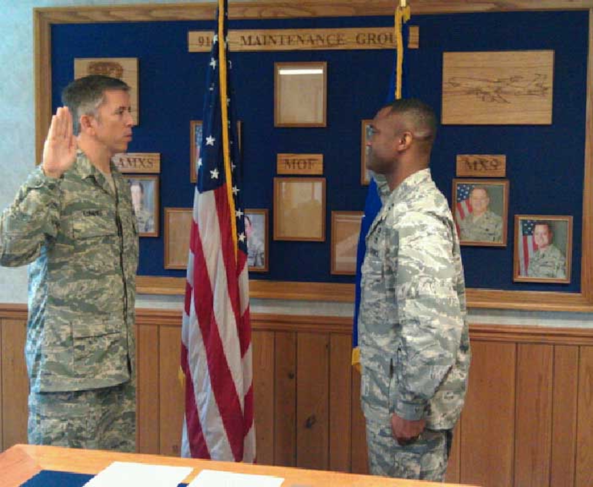 Master Sgt. Tony Banks (left) 916th Maintenance Squadron, is given his re-enlistment from Capt. Jarius Wallace during the August drill weekend. (USAF photo courtesy of 916MXS)