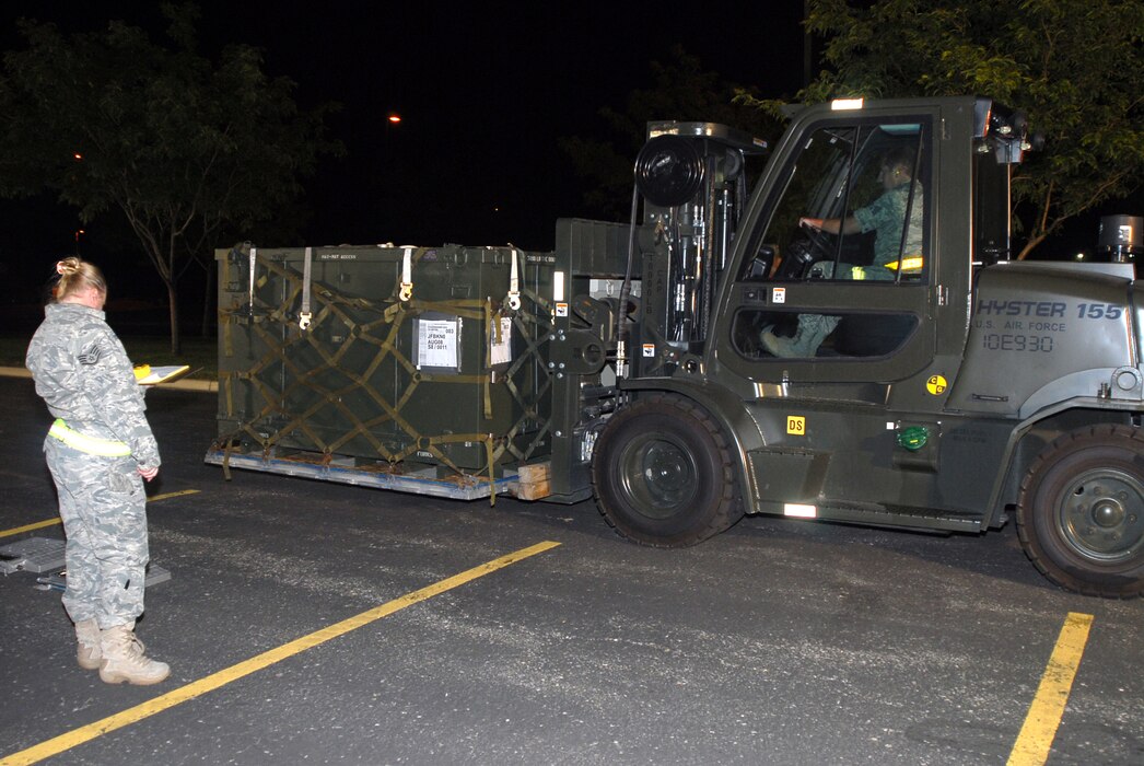 Cargo is moved through the Cargo Deployment Function during the night shift August 5, 2011.  As part of Exercise Double Whammy, operations ran through the night to simulate a real-world deployment situation. (U.S. Air Force photo by A1C Emily Hulse) 