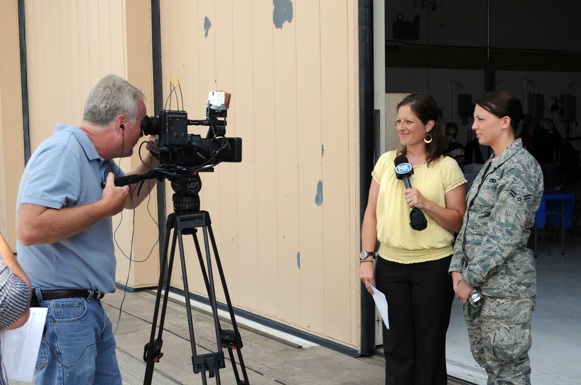 Airman 1st Class Elizabeth Freeman of the 148th Fighter Wing, Duluth, Minn, who just returned from basic military school (BMT) and tech school, talks to to a reporter about BMT in Duluth, Minn. On August 7, 2011. Fox Sports North (FSN) and the Minnesota Twins are show-casing the First Lady's "Joining Forces" campaign by celebrating military members and their families during a series of Sunday Twins Games where they will be airing their pre and post games shows from military installations. (U.S. Air Force photo by Staff Sgt. Donald L. Acton)