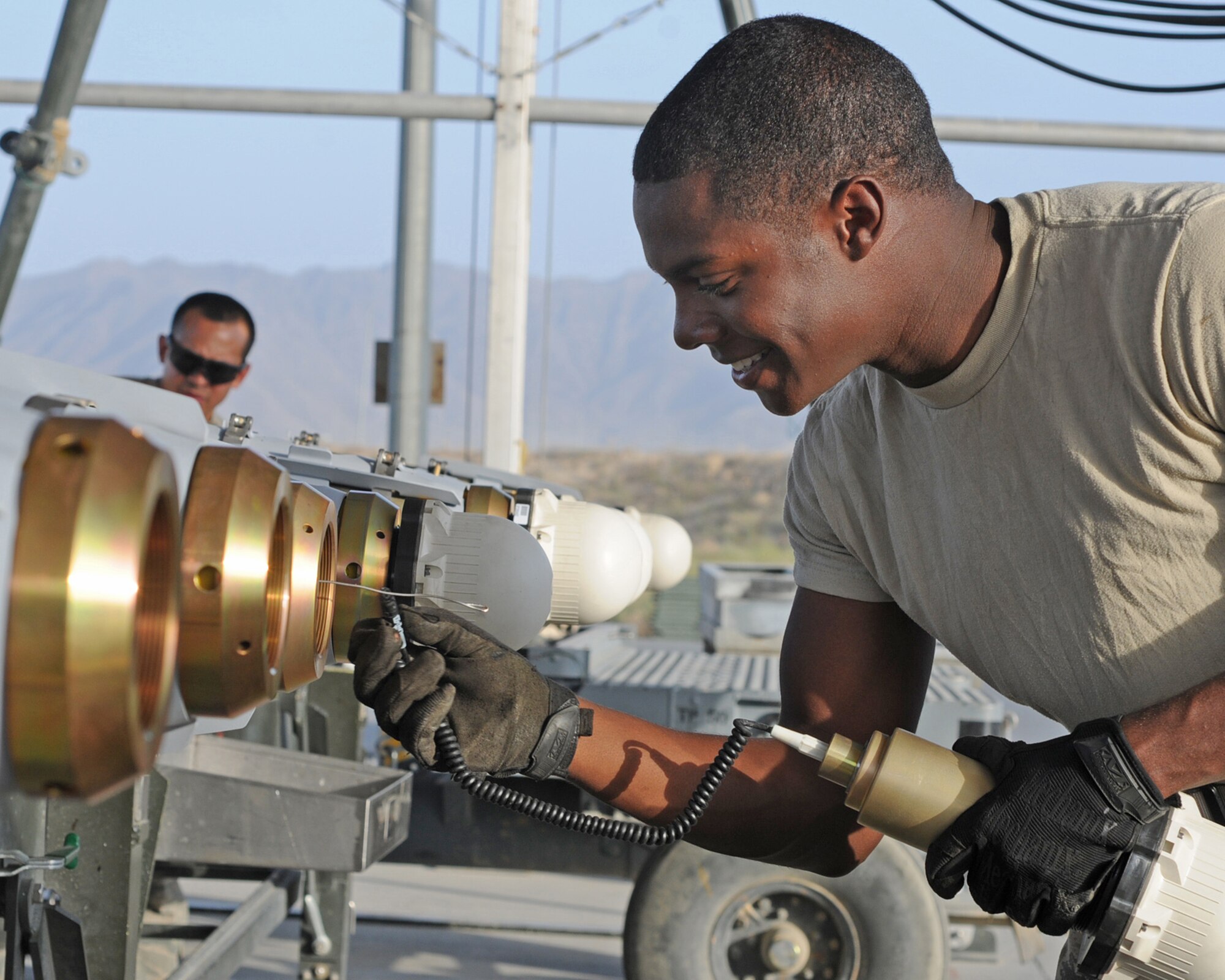 BAGRAM AIRFIELD, Afghanistan -- Airman 1st Class Alex Presley, 455th Expeditionary Maintenance Squadron munitions systems specialist builds a GB-38 bomb here Aug. 5, 2011. Presley, deployed from Aviano Air Base, Italy, is replenishing the stock on the munitions assembly conveyor. (U.S. Air Force photo/Senior Airman Krista Rose)
