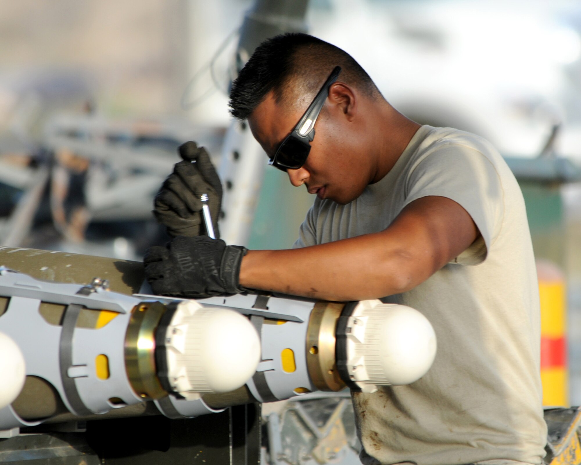 BAGRAM AIRFIELD, Afghanistan -- Staff Sgt. Mark Christy, 455th Expeditionary Maintenance Squadron munitions systems specialist, builds a GB-38 bomb here Aug. 5, 2011. Christy, deployed from Aviano Air Base, Italy, is replenishing the stock on the munitions assembly conveyor. (U.S. Air Force photo/Senior Airman Krista Rose)