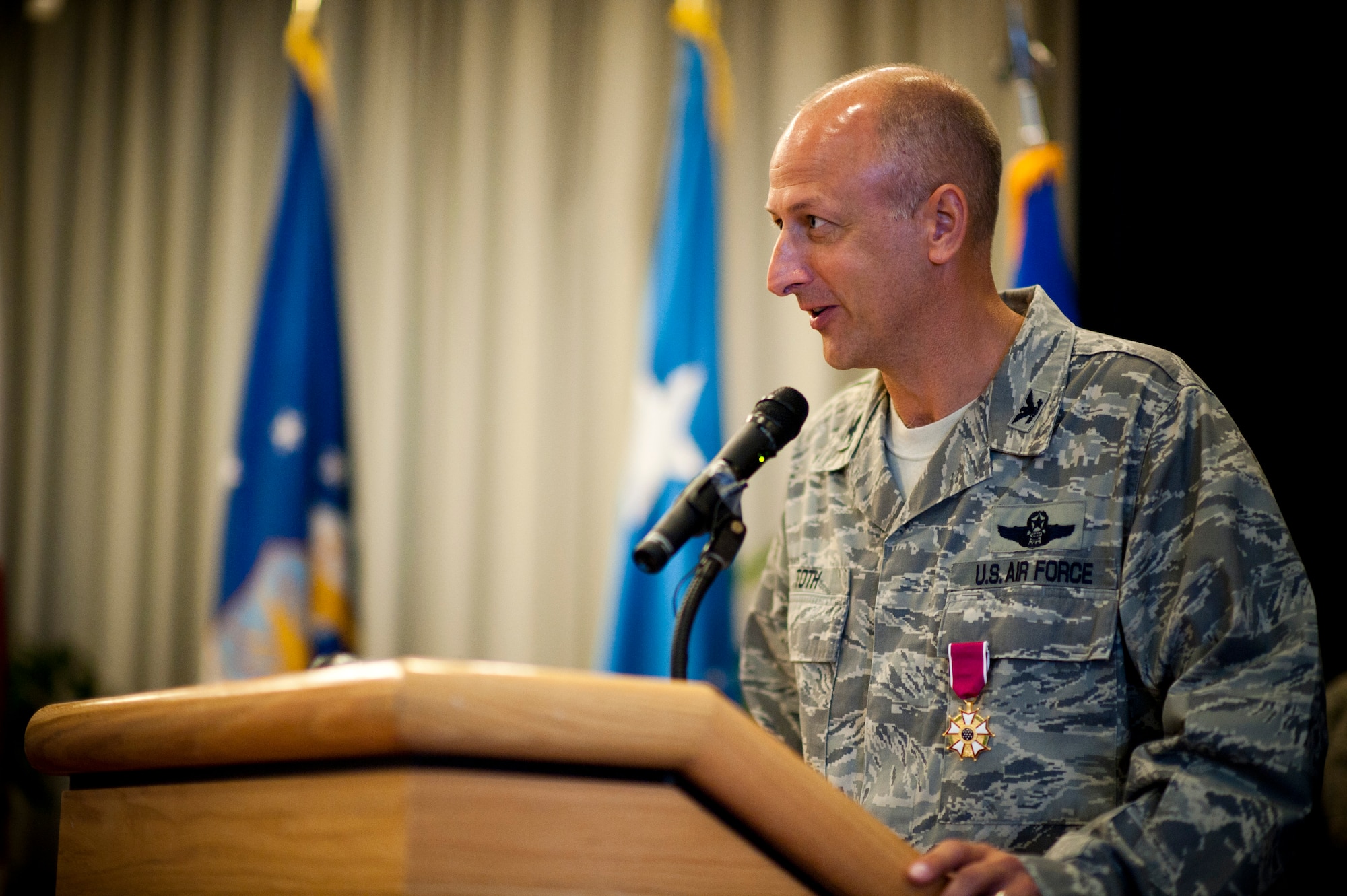YOKOTA AIR BASE, Japan -- Col. Robert Toth, the previous 353rd Special Operations Group commander, addresses the Pacific Air Commandos and other guests shortly after relinquishing command during a ceremony here Aug. 5. The ceremony was held at the Officers' Club here two days after Airmen and aircraft evacuated Kadena Air Base for Typhoon Mufia. (U.S. Air Force photo by Staff Sgt. Sam Morse)
