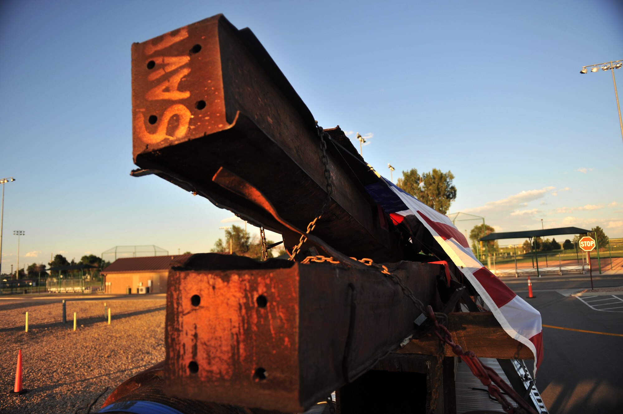 BUCKLEY AIR FORCE BASE, Colo. --Shown are more than 230,000 pounds of steel from the World Trade Center draped by an American flag here Aug. 7, 2011.  These pieces will be used in memorials commemorating the 10th anniversary of the 9/11 attacks. (U.S. Air Force Photo by Airman 1st Class Phillip Houk)