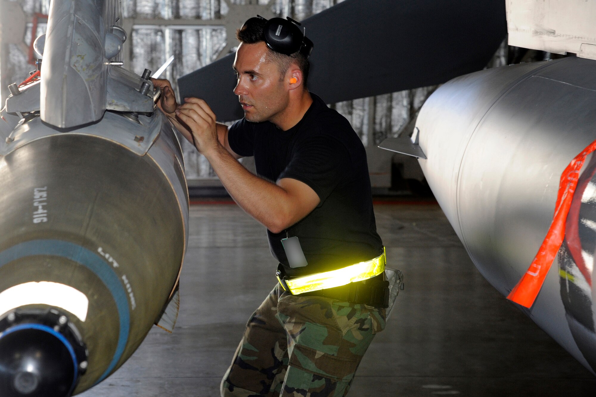 MISAWA AIR BASE, Japan -- Staff Sgt. Patrick Cannon, 14th Aircraft Maintenance Unit, performs a final inspection of the F-16 Fighting Falcon during the load crew-of-the-quarter competition Aug. 5. The competition is held once a quarter and participants are selected based on their loading proficiency and skill. The 14th AMU won this quarter's competition and will compete later in the year for the title of "load crew of the year." (U.S. Air Force photo/Staff Sgt. Marie Brown)