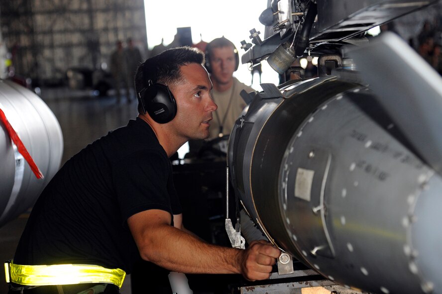 MISAWA AIR BASE, Japan -- Staff Sgt. Patrick Cannon, 14th Aircraft Maintenance Unit, lines up the Joint Direct Attack Munition GBU-31 bomb lugs prior to being loaded on an F-16 Fighting Falcon during the load crew-of-the-quarter competition Aug. 5. The JDAM GBU-31 is a 2,000-pound class munition guided by a tail kit. (U.S. Air Force photo/Staff Sgt. Marie Brown)