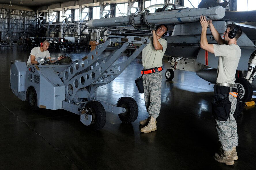 MISAWA AIR BASE, Japan -- Members of the 13th Aircraft Maintenance Unit compete for load crew-of-the-quarter during a competition Aug. 5. The loading competition takes place each quarter at Misawa. Aside from bragging rights the competition demonstrates proper loading proficiency. (U.S. Air Force photo/Staff Sgt. Marie Brown)