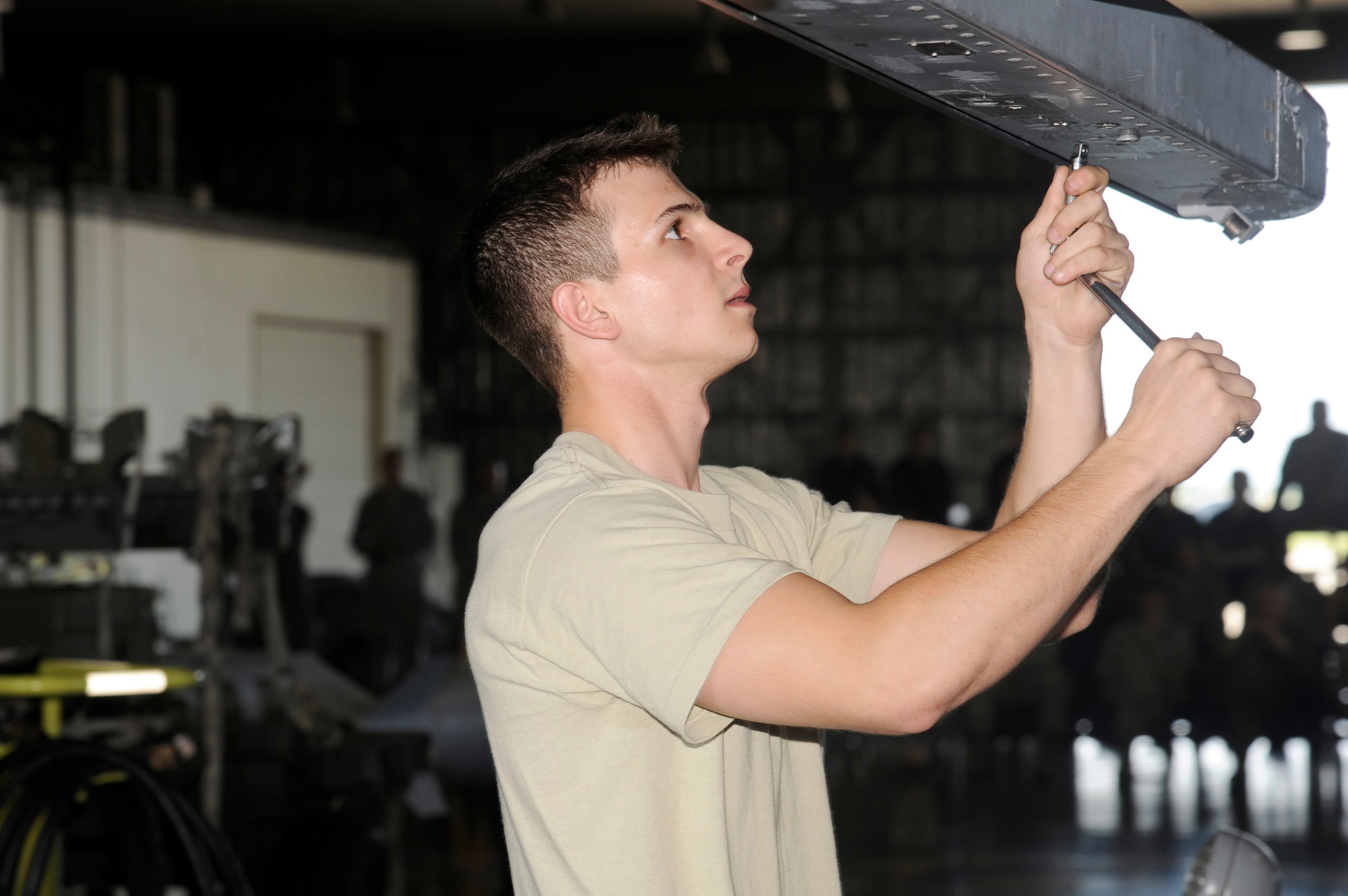 MISAWA AIR BASE, Japan -- Airman 1st Class Vincent Falletta, 13th Aircraft Maintenance Unit, prepares the LAU-129 Guided Missile Launcher prior to being loaded during the load crew-of-the-quarter competition Aug. 5. The load crew is made up of a three member team which is responsible for getting the aircraft ready and preparing munitions. (U.S. Air Force photo/Staff Sgt. Marie Brown)