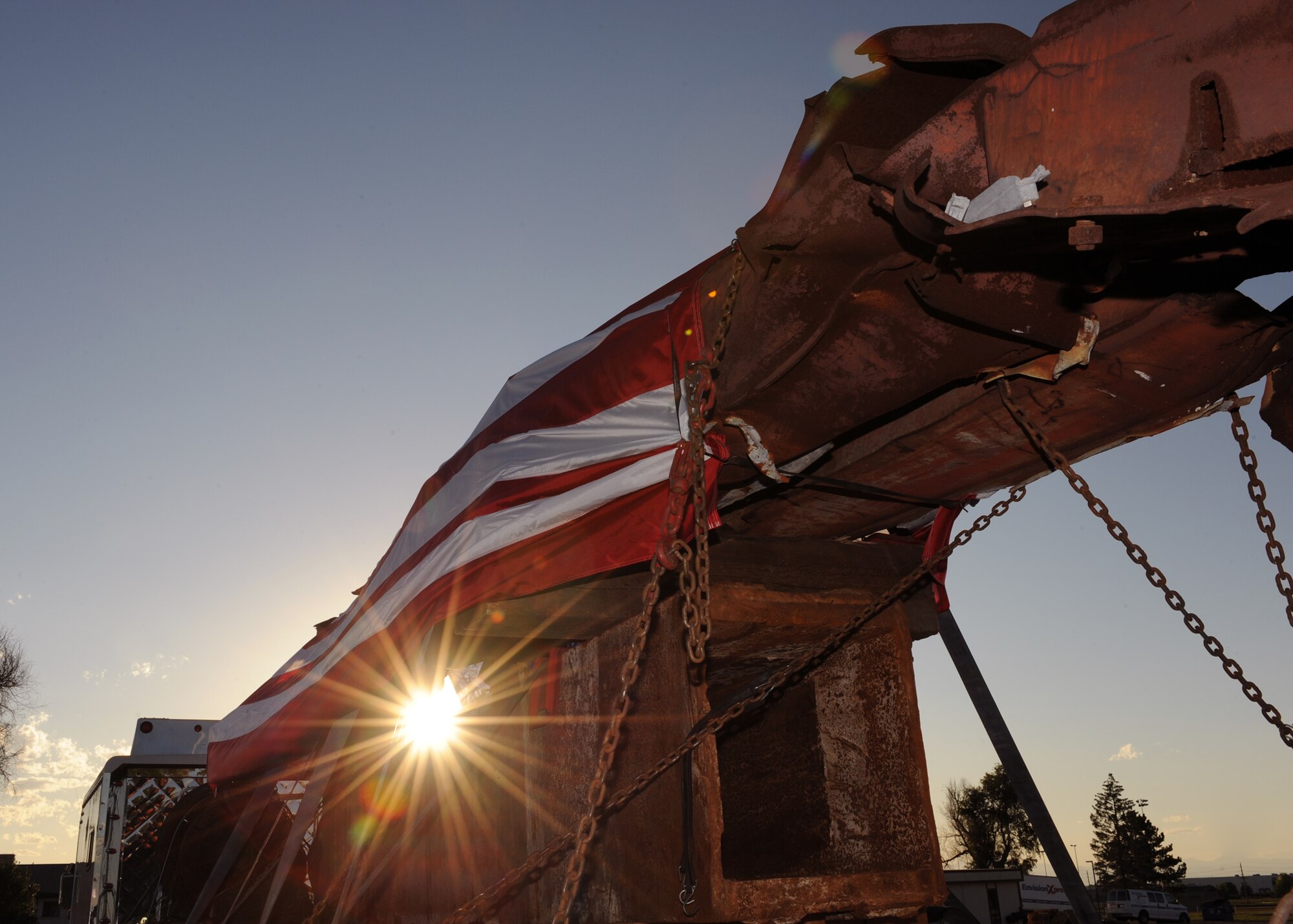 BUCKLEY AIR FORCE BASE, Colo. --  The sun sets on pieces of the World Trade Center Aug. 7, 2011. Buckley AFB provided a safe haven for the honored pieces on the journey to their final destination. These pieces will be distributed around Denver to commemorate the 10th anniversary of 9/11.  (U.S. Air Force photo by Senior Airman Marcy Glass)
