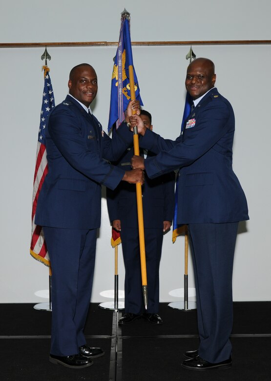 Col. Dwayne Thomas (left), 36th Mission Support Group commander, passes the 36th Force Support Squadron guidon to Maj. Craig Smalls, newly appointed 36 FSS commander, during a change of command ceremony here July 19.(U.S. Air Force photo/ Senior Airman Carlin Leslie)

 
