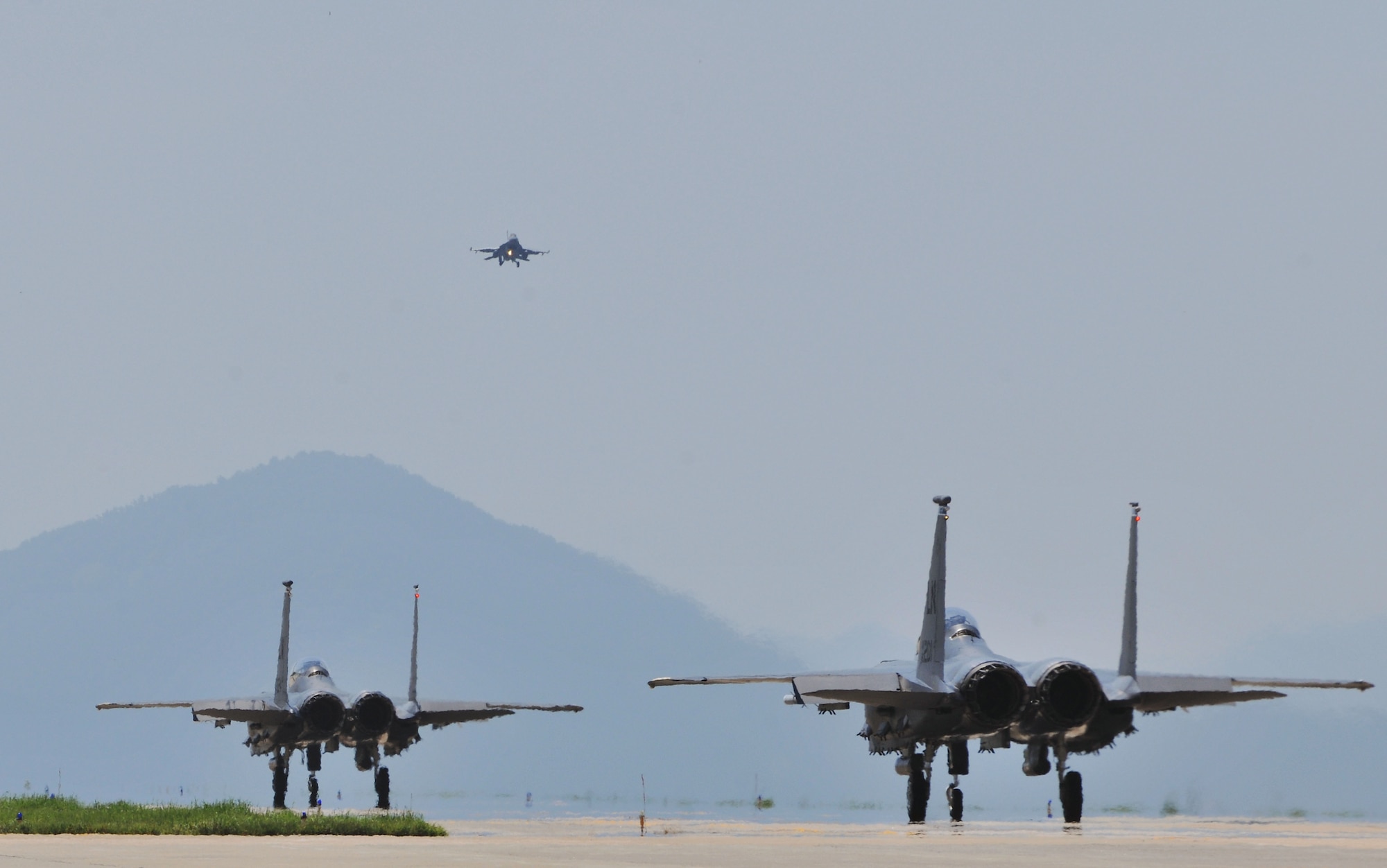 KUNSAN AIR BASE, Republic of Korea -- Two F-15E Eagle Strike taxi down the flightline here Aug. 5. Army and Air Force units teamed up for a joint training exercise at Jikdo Island, firing AGM-114 Hellfire missiles, rockets and 30mm munitions at the range. (U.S. Air Force photo/Senior Airman Brittany Y. Bateman)