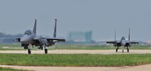 KUNSAN AIR BASE, Republic of Korea -- Two F-15E Eagle Strike taxi down the flightline here Aug. 5. Army and Air Force units teamed up for a joint training exercise at Jikdo Island, firing AGM-114 Hellfire missiles, rockets and 30mm munitions at the range. (U.S. Air Force photo/Senior Airman Brittany Y. Bateman)