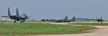 KUNSAN AIR BASE, Republic of Korea -- Two F-15E Eagle Strike taxi down the flightline here Aug. 5. Army and Air Force units teamed up for a joint training exercise at Jikdo Island, firing AGM-114 Hellfire missiles, rockets and 30mm munitions at the range. (U.S. Air Force photo/Senior Airman Brittany Y. Bateman)